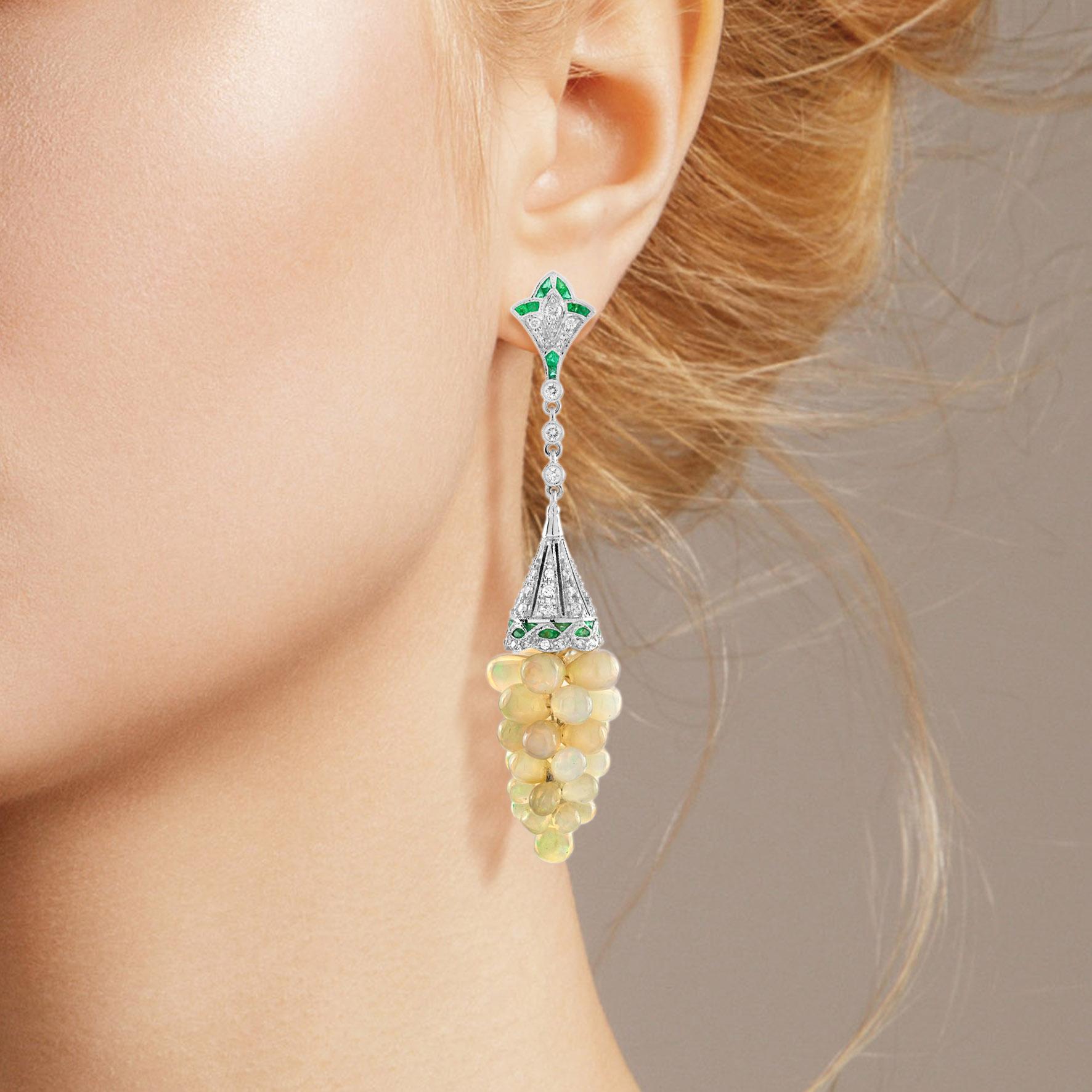 Dress up her ears in nature inspired elegance with these sophisticated opal grape dangle earrings. Crafted in 18k white gold, each earring showcases an inspiring grape drop design shimmering with total 1.60 carats emeralds and 0.93 carat diamond.