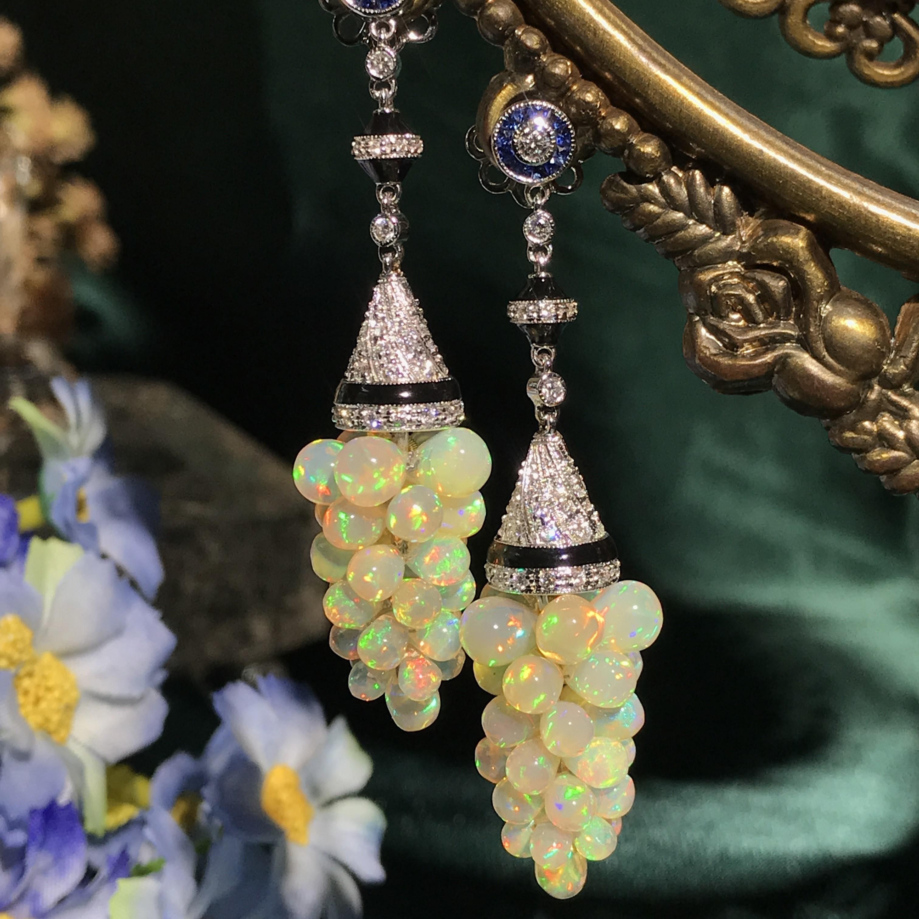 Dress up her ears in nature inspired elegance with these sophisticated opal grape dangle earrings. Crafted in 18k white gold, each earring showcases an inspiring grape drop design shimmering with total 0.55 carats blue sapphire and 0.93 carat