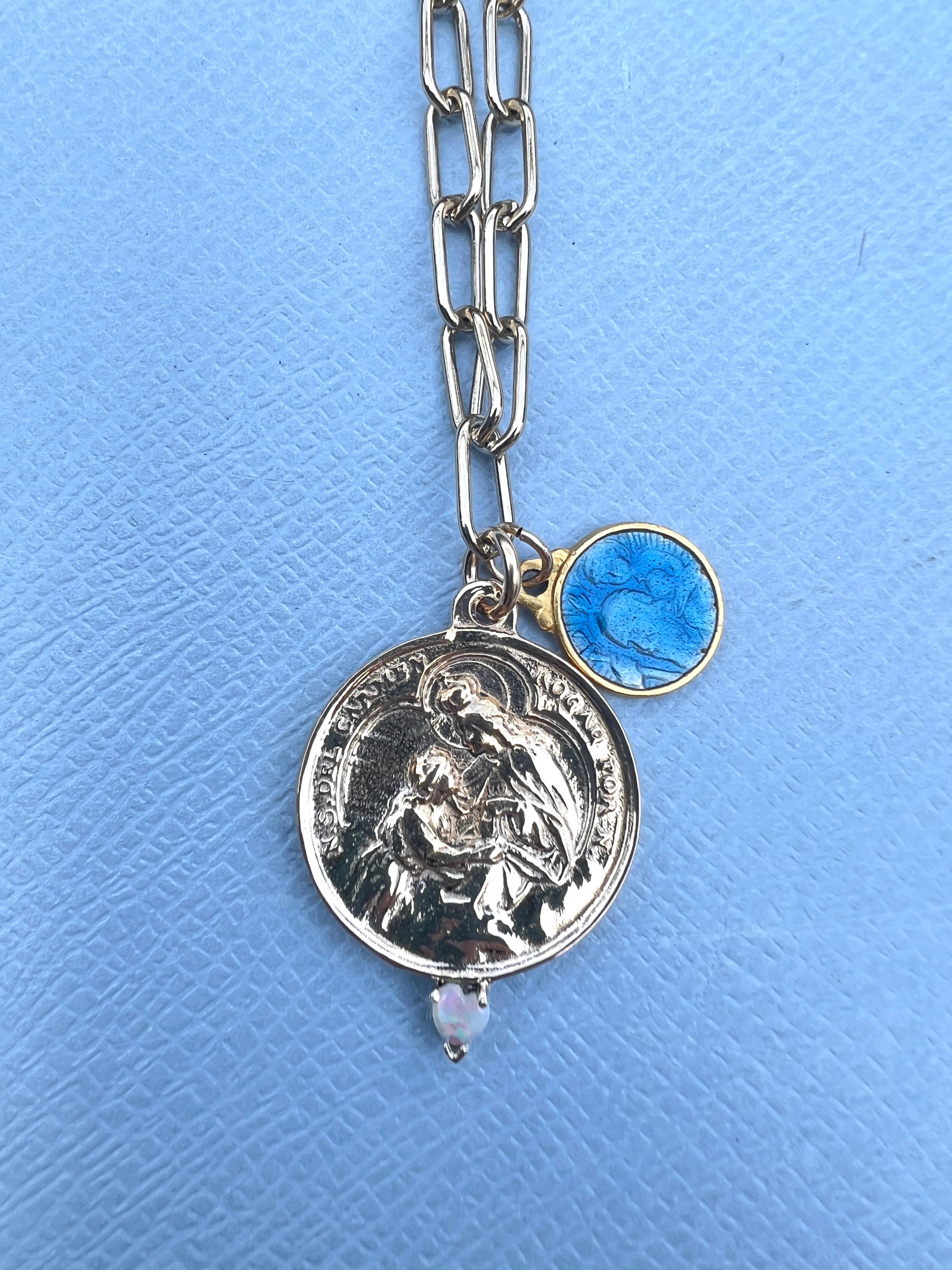 Opal Heart set in a silver prong on a Spanish Carmen Medal in Bronze, The Chain is Gold filled and has additionally a part of a Pearl Rosario, and has a small Vintage French Blue Enamel Virgin Mary that is Gold plated.

The Chain is 28' long but can