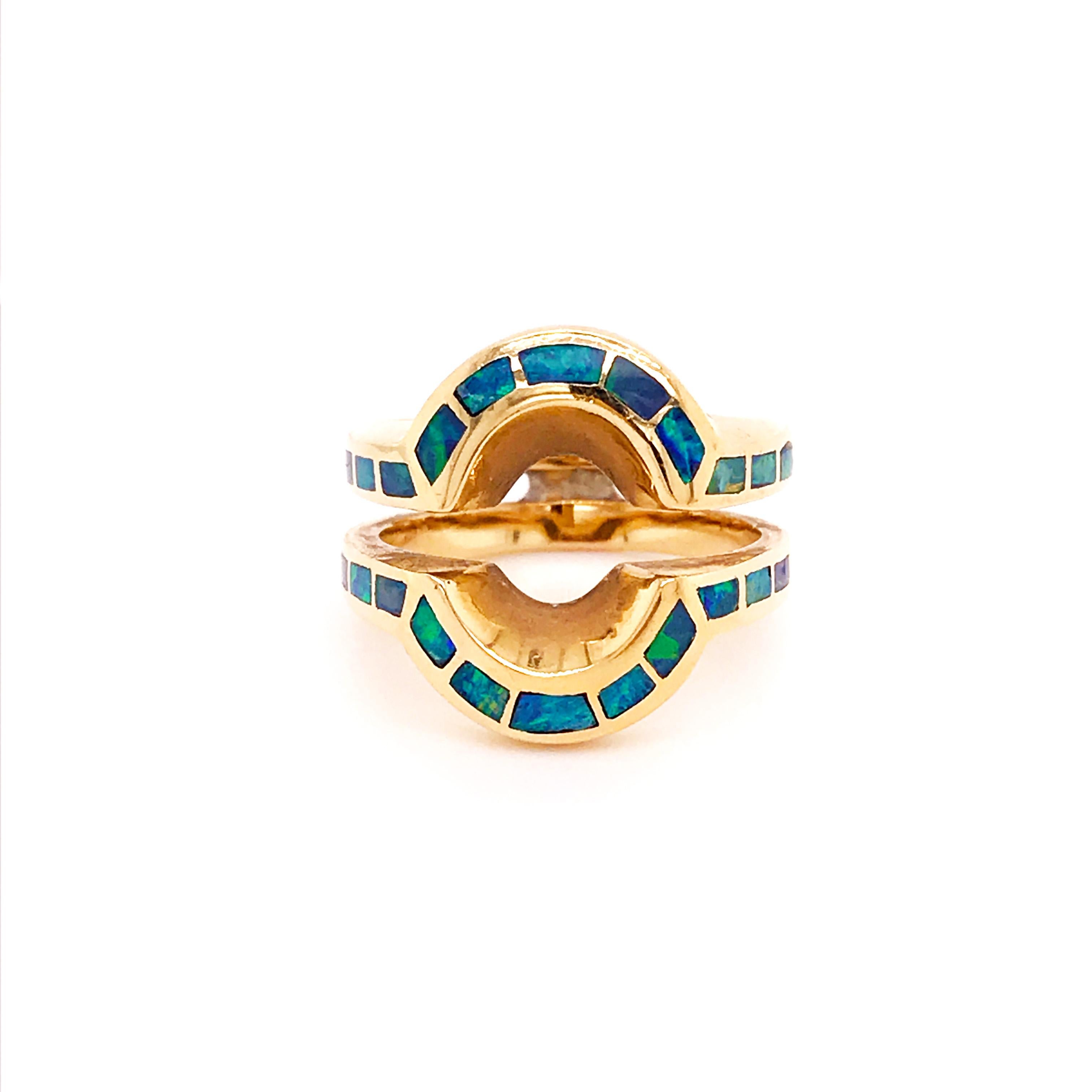 This estate ring enhancer ring guard is an original, one of a kind piece. With blue opal inlay on 14k yellow gold. Cutting opal to fit in an inlay ring takes special skills that most jewelers do not have.  This inlay was artfully done.  The deep