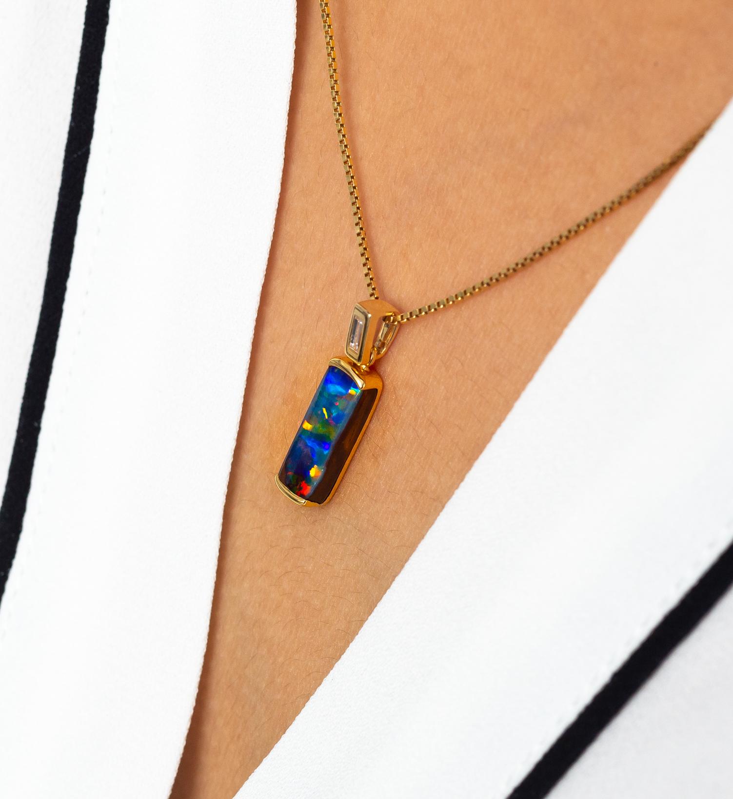 'Before Sunrise' is a vibrant opal pendant with an Australian opal (2.54ct) and a baguette diamond (0.06ct) bale. Fresh and dainty, it adds a touch of graceful panache to a work suit or an elegant dress, or an understated fashion ensemble. It is