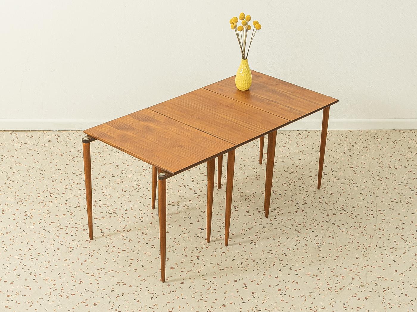 Rare nesting tables from the 1960s. High-quality solid walnut frame and table top in walnut veneer.

Quality features:
- Very good workmanship
- High-quality materials
- Made in Germany, manufacturer: Opal Möbel (Branding on the frame)