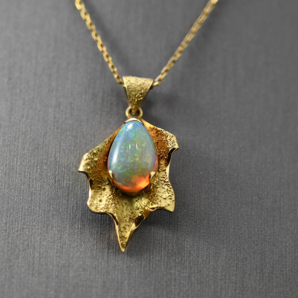 Ethiopian opal pendant necklace.
The pendant setting is stamped 18k and weighs 8.8 grams gross weight.
The opal is pear shape and measures 15.25mm by 10mm by 7mm.
The color pattern is bold and distinct, definetly premium quality.
The play of color