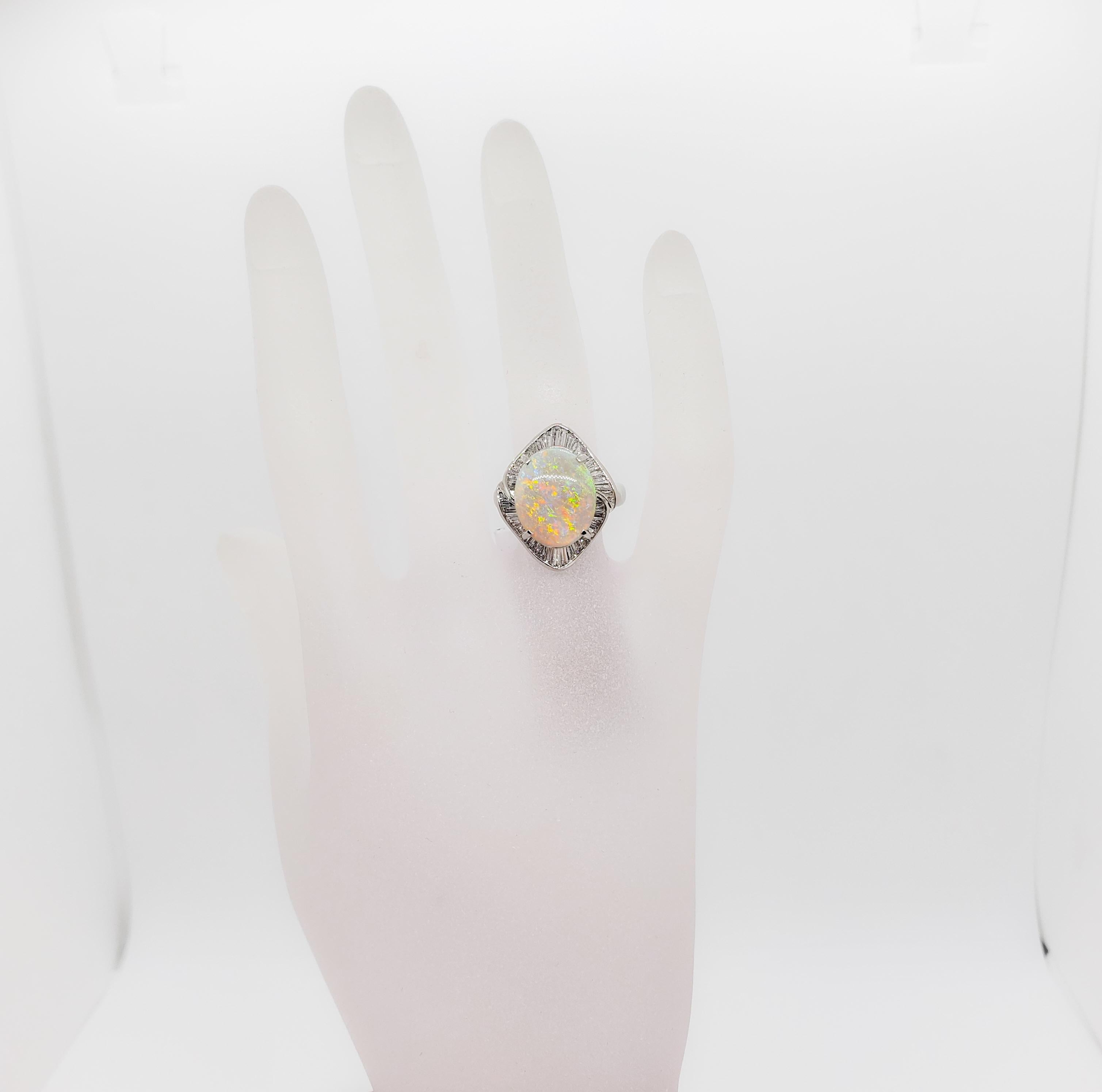 Beautiful 5.80 ct. white opal oval with 0.91 ct. of good quality white diamond baguettes.  Handmade platinum mounting in size 6.5.  Mint condition.