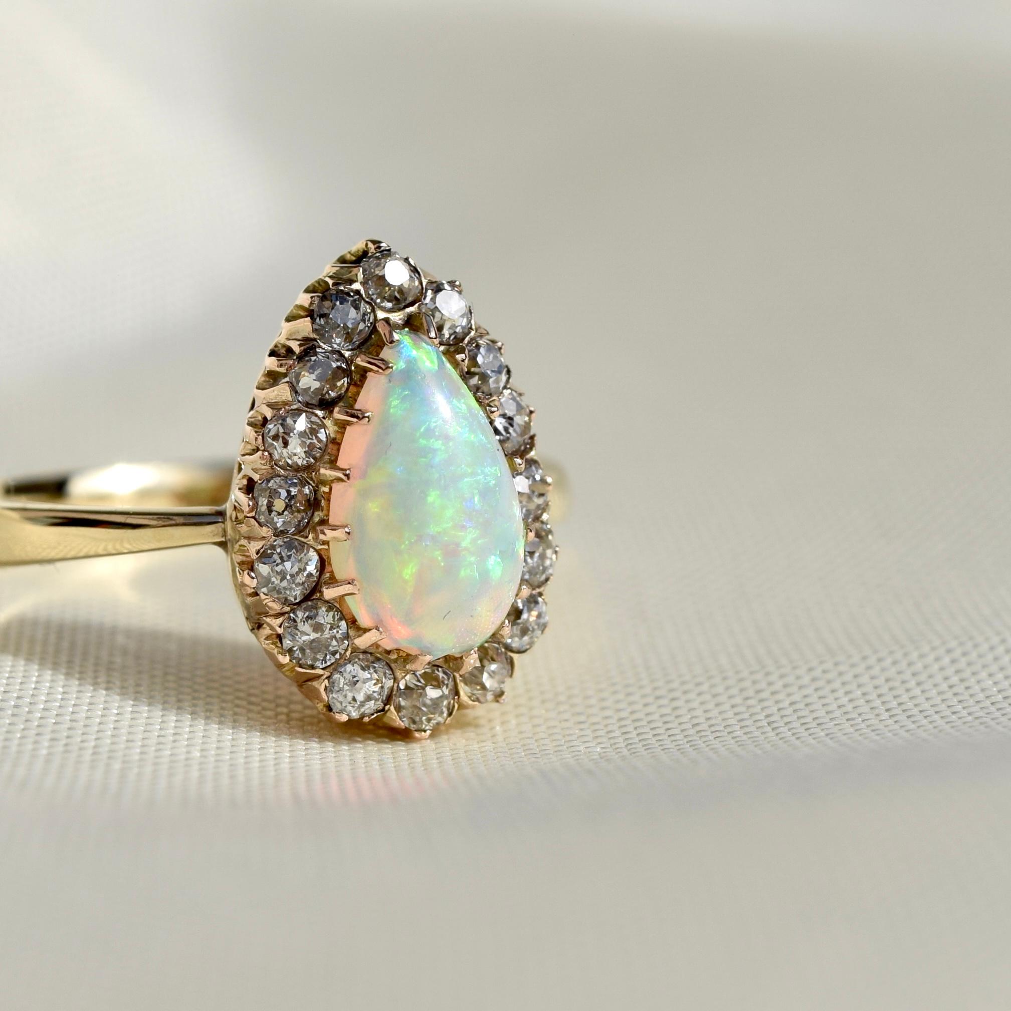 The head of this ring was made in France around 1900, the band was added recently. In excellent condition. 

- One natural opal cabochon, 8x5mm
- Sixteen old mine cut diamonds, each 1.5x1.5mm/ 0.02ct 
- Total diamond weight: approx. 0.32ct 
- 585/