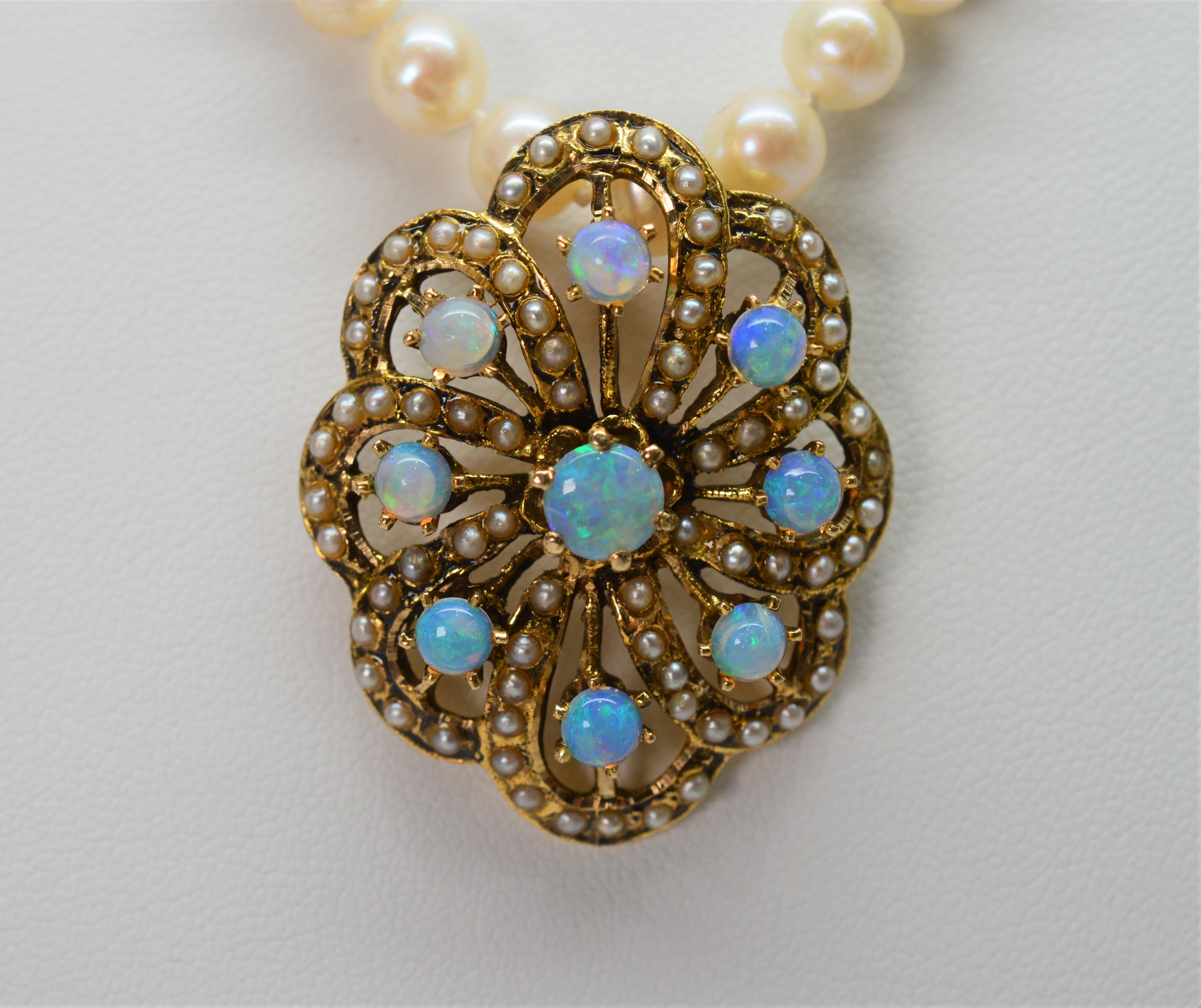 Gorgeous oval fourteen karat 14K yellow gold antique style filigree pendant fully adorned with tiny pearls proudly displays nine colorful round cut  iridescent opals that catch the light and display beautiful hues of blue and pink. Suspended on a