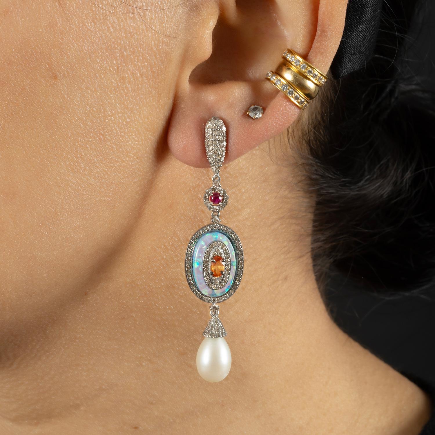 An interesting combination of consciously sourced stones, consciously hand crafted, giving the earring a beautiful colour pop.

Single cut diamonds; (3.30 carat); Opal (11.35 carat); Pearl (0.60 carat); Coloured Tourmaline & Sapphire (1.50