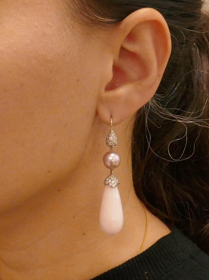 Classy and elegant dangle earrings created by Donald Huber. Feminine, chic and wearable, the earrings are a great addition to your jewelry collection. 
The earrings are made of 18 karat white gold (stamped) and feature two pink opals and two pearls