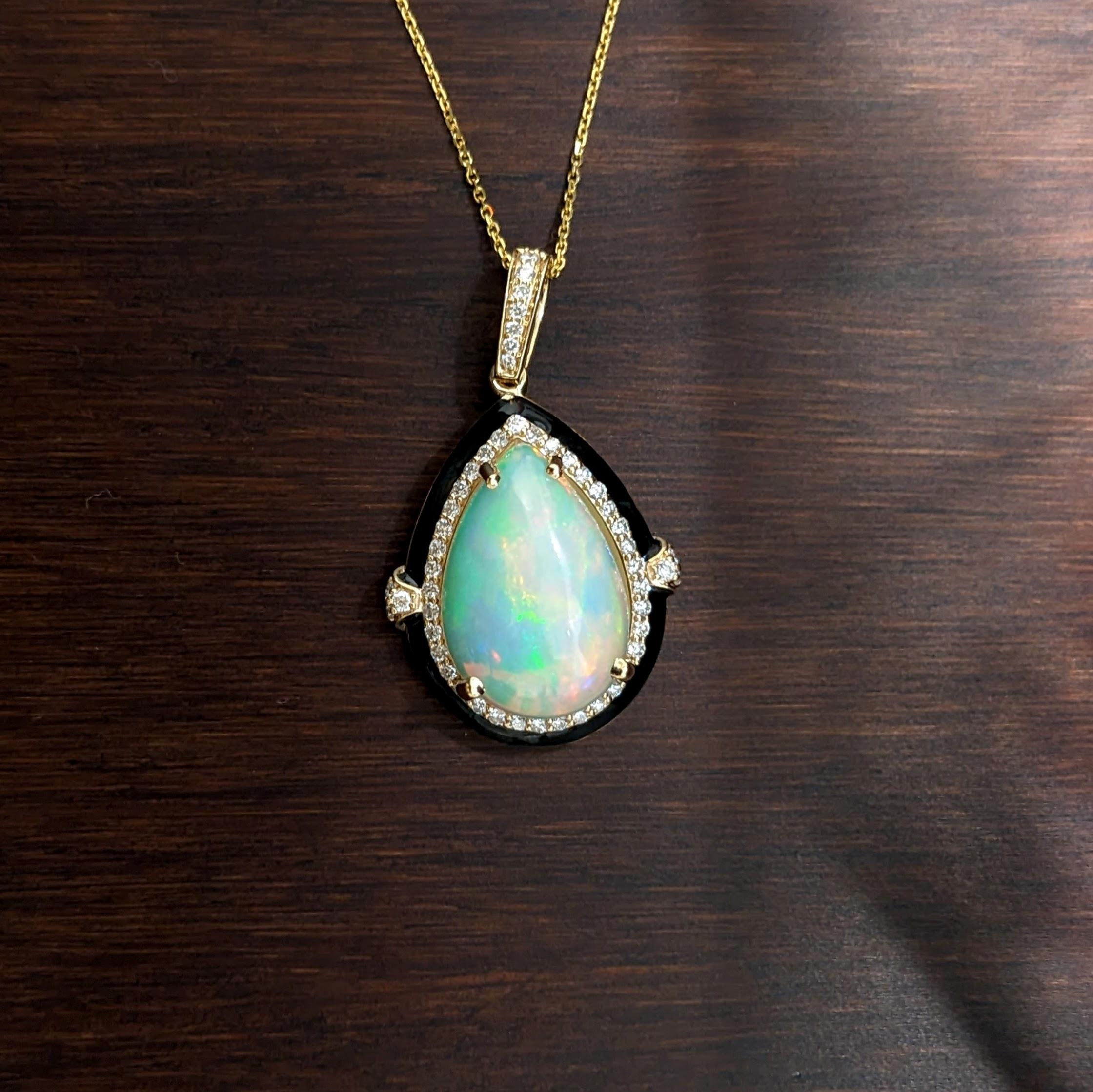 A simply stunning new NNJ pendant design featuring a gorgeous play of color pear shape cabochon opal with a natural diamond halo and black enamel. A perfect contrast to make those fiery colors pop! This is a must have for opal lovers, a classy and