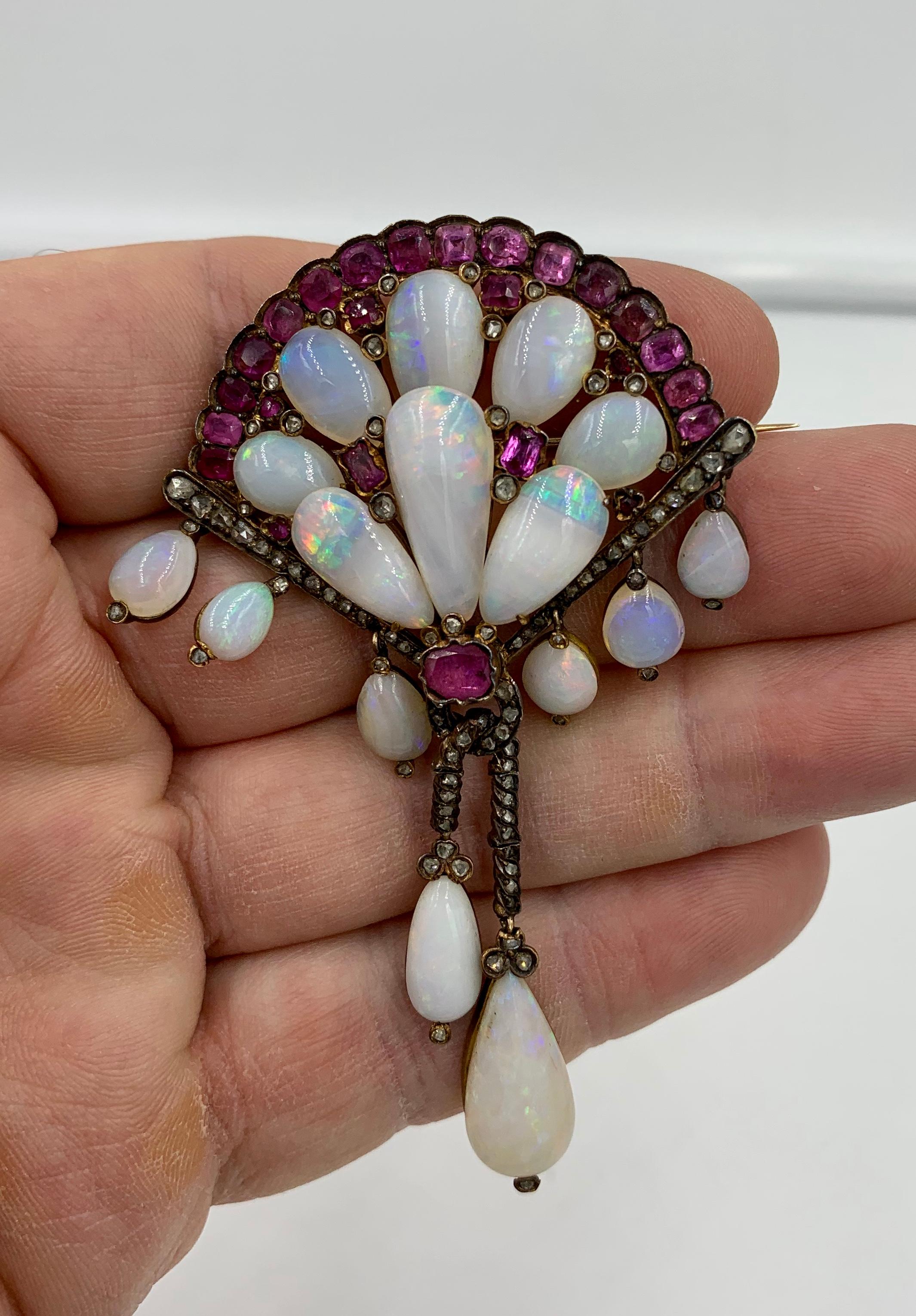 A spectacular antique fan motif brooch with 16 extraordinary pear shape cabochon cut Opals, 23 stunning Pink Sapphires, and 88 sparkling Rose Cut Diamonds. The Opals are just out of this world.  It is extremely rare to find antique jewels with opals