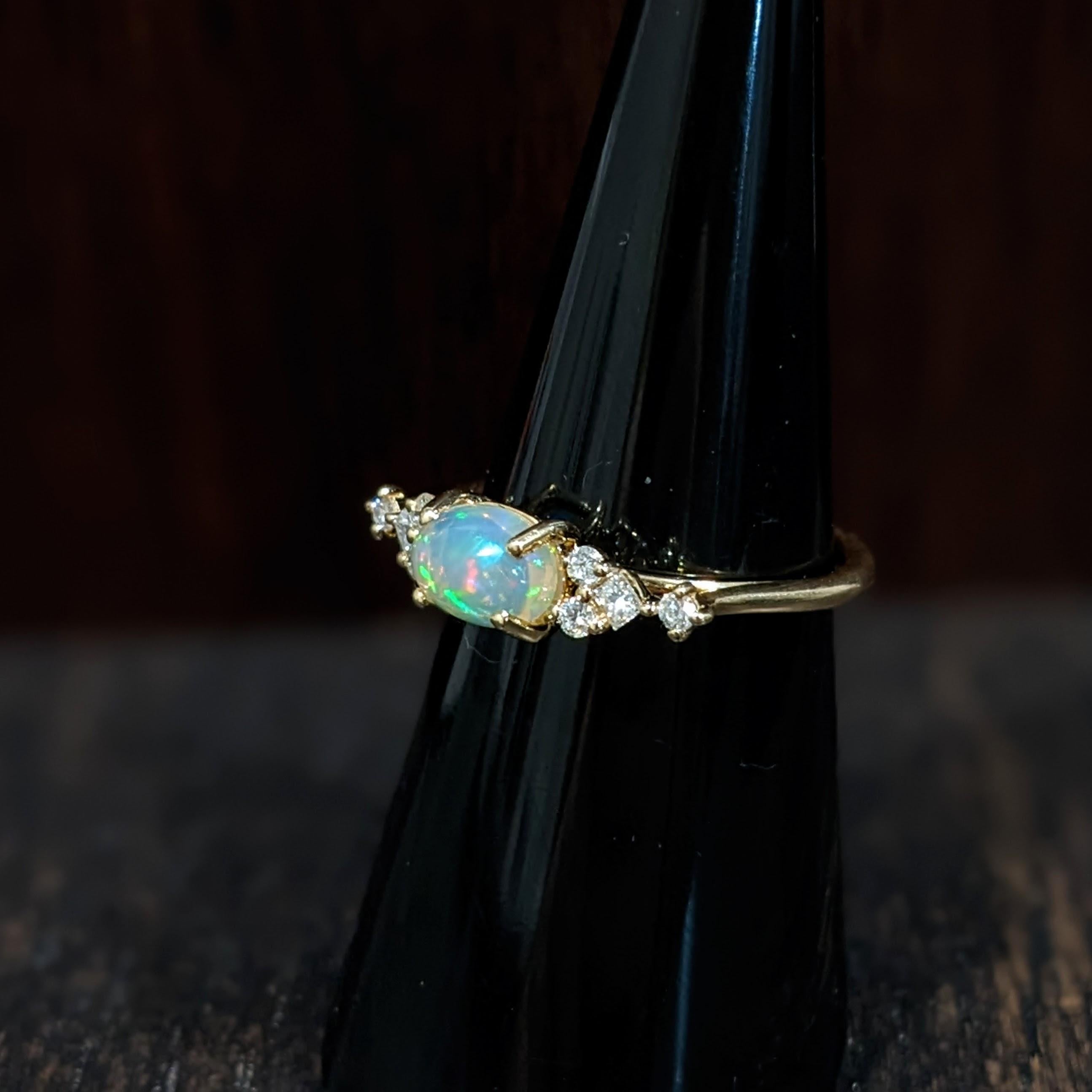This lovely opal has all the colors of the rainbow, accented with natural earth mined diamond accents. This oval ring is perfect for the modern bride or that special someone in your life! This opal ring also makes a beautiful October birthstone gift