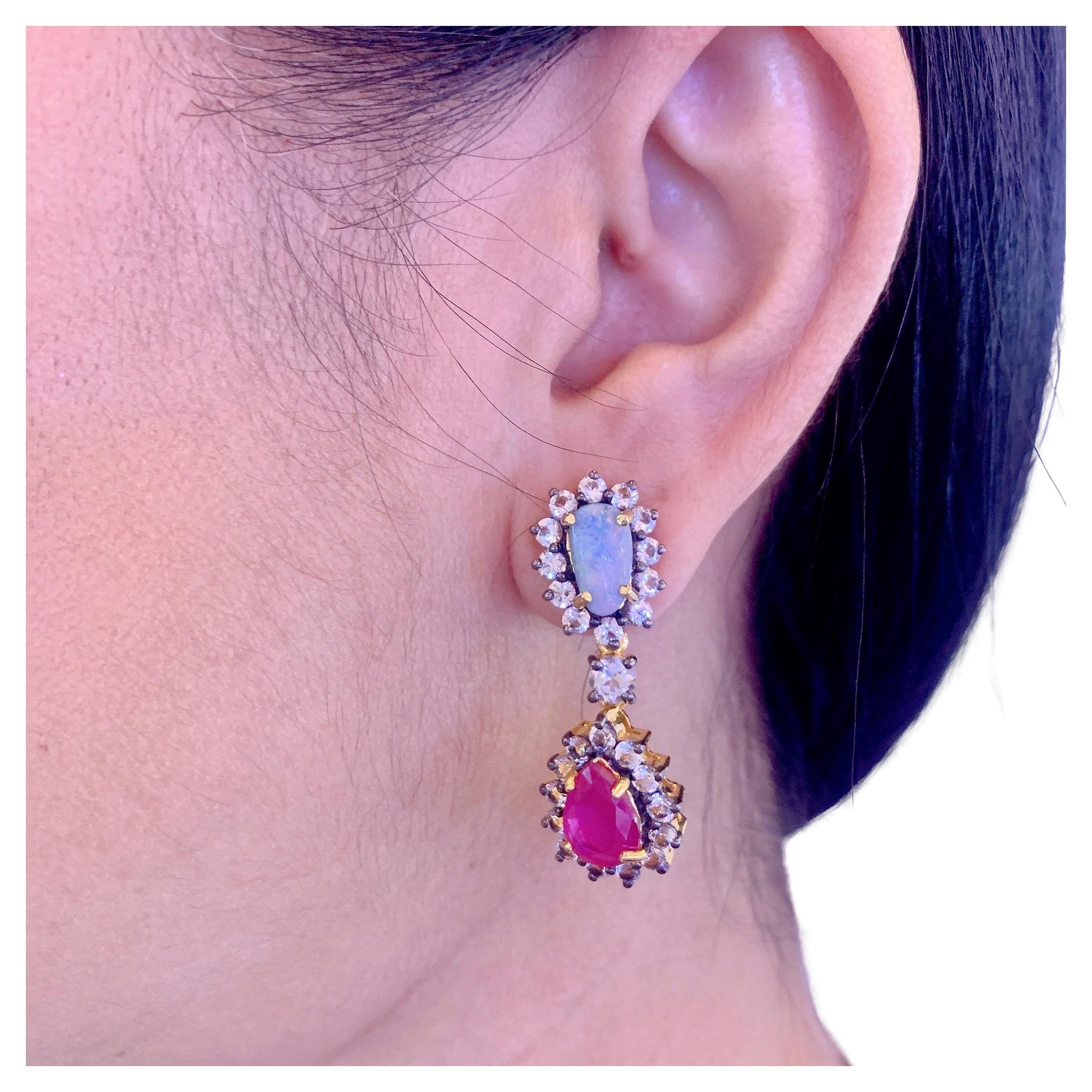 Opal. Ruby & White Topaz Candy Earrings, Silver & 22k Pink Gold
Natural Opal 
6 carats 
Color white, blue, silver 
Natural Ruby 
Shape - pear shape 
12 carats 
White Topaz 
Shape - round brilliant 
9 carats 
22K Pink Gold and Silver 
This earrings