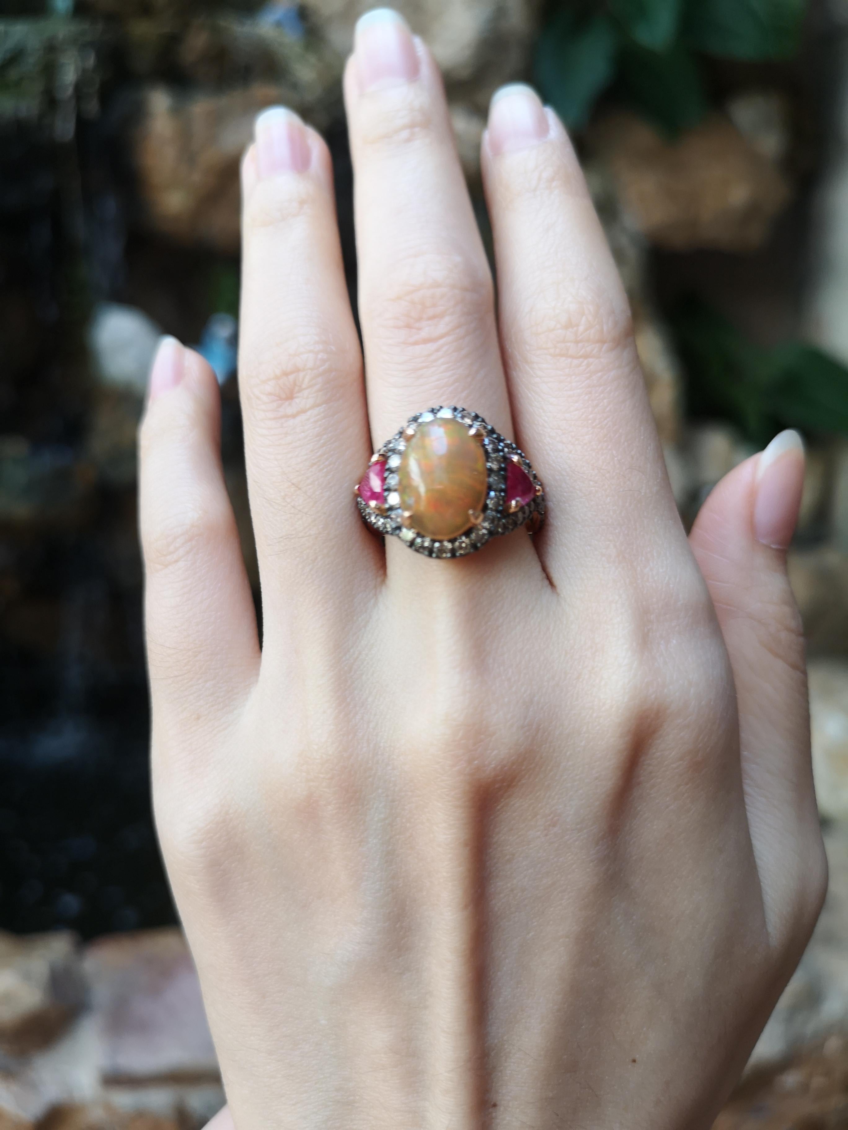 Opal 2.56 carats, Ruby 1.22 carats with Brown Diamond 1.32 carats Ring set in 18 Karat Rose Gold Settings

Width: 1.7 cm
Length: 1.5 cm 
Ring Size: 53

