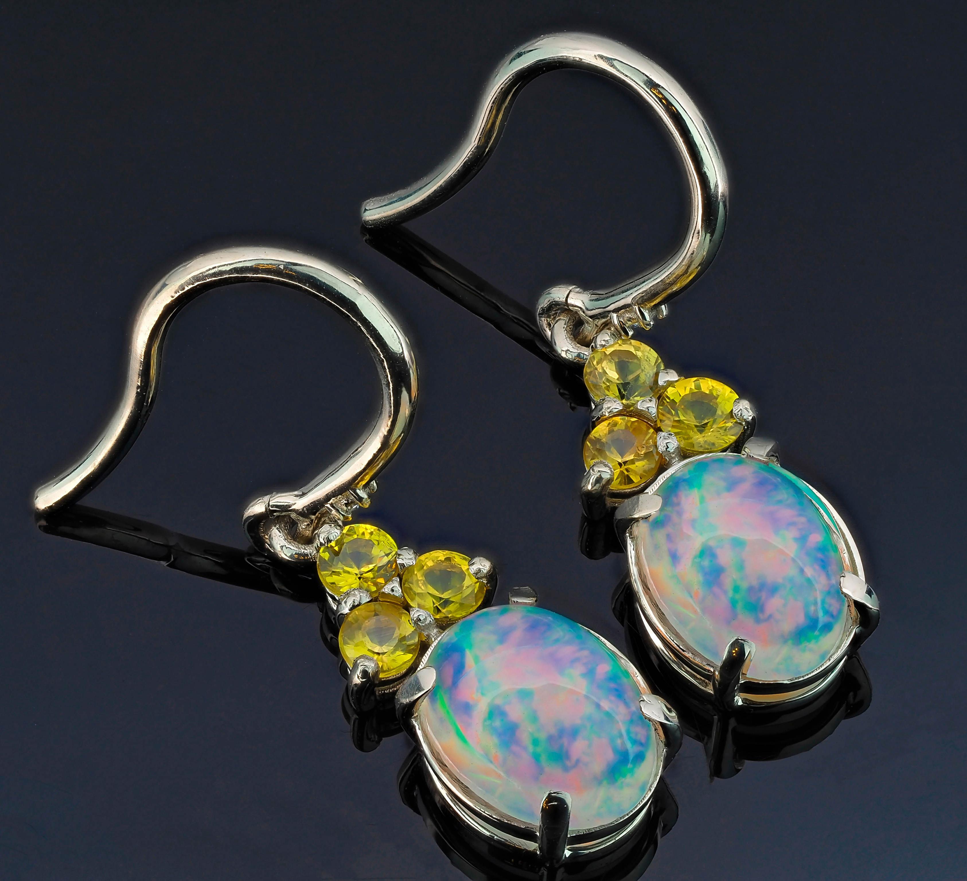 Opal, sapphire 14k gold earrings. 
Vintage opal earrings. Ethiopian opal earrings. October Birthstone earrings. Oval cabochon opal earrings.

Metal: 14k gold.
Weight: 2.5 g.
Size 25x 6 mm.

Set with Opals 2 pieces, color - mix colors
Oval cut, aprox