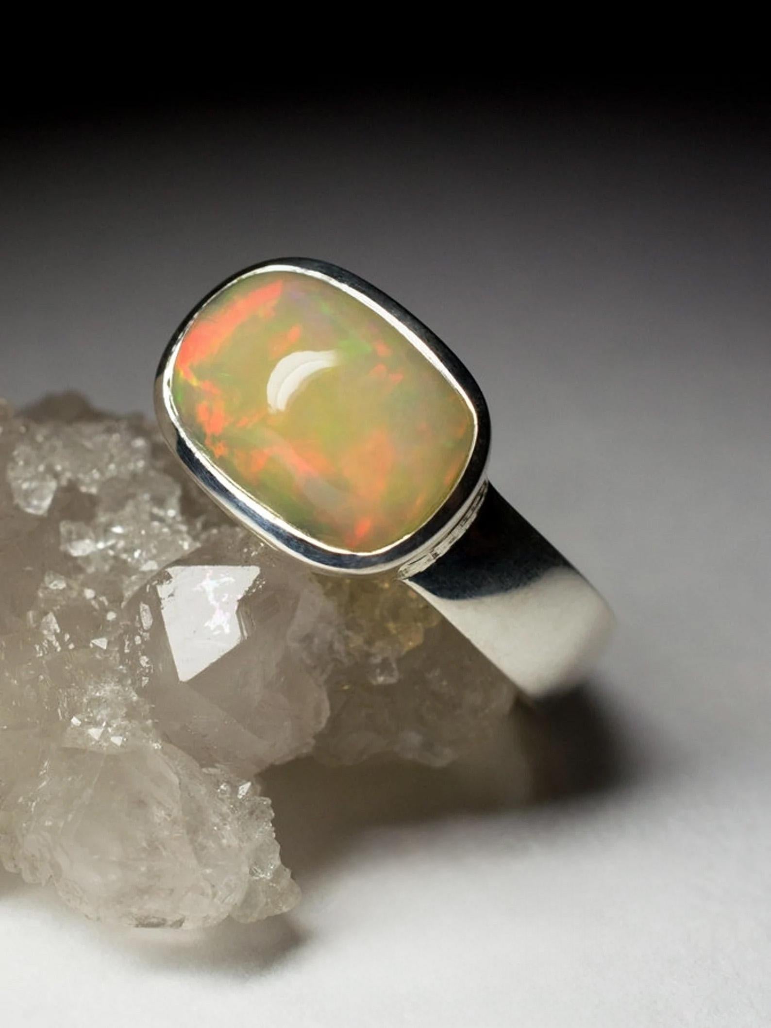 Silver ring with natural Opal in a cabochon cut 
gemstone origin - Ethiopia
ring weight - 4.60 grams
ring size - 8 US
gemstone weight - 3.9 carat
gemstone size - 0.28 х 0.35 x 0.51 in / 7 х 9 х 13 mm