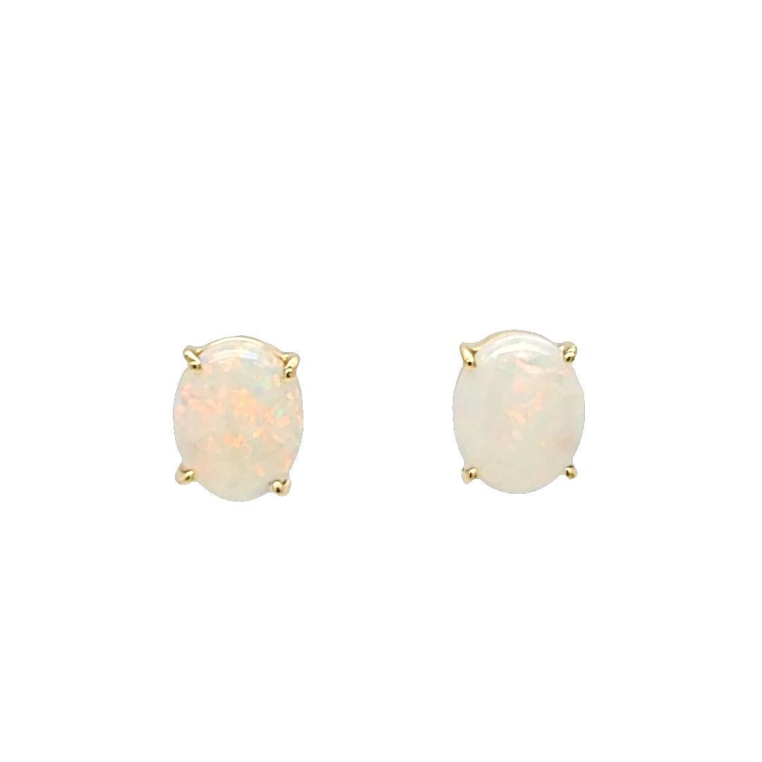 14 Karat Yellow Gold Oval Stud Earrings Featuring Two 10mm x 8mm Cabochon Opals Weighing Approximately 3.00 Carats with Lots of Play of Color Including Red and Orange Flashes. Pierced Post with Friction Back.
