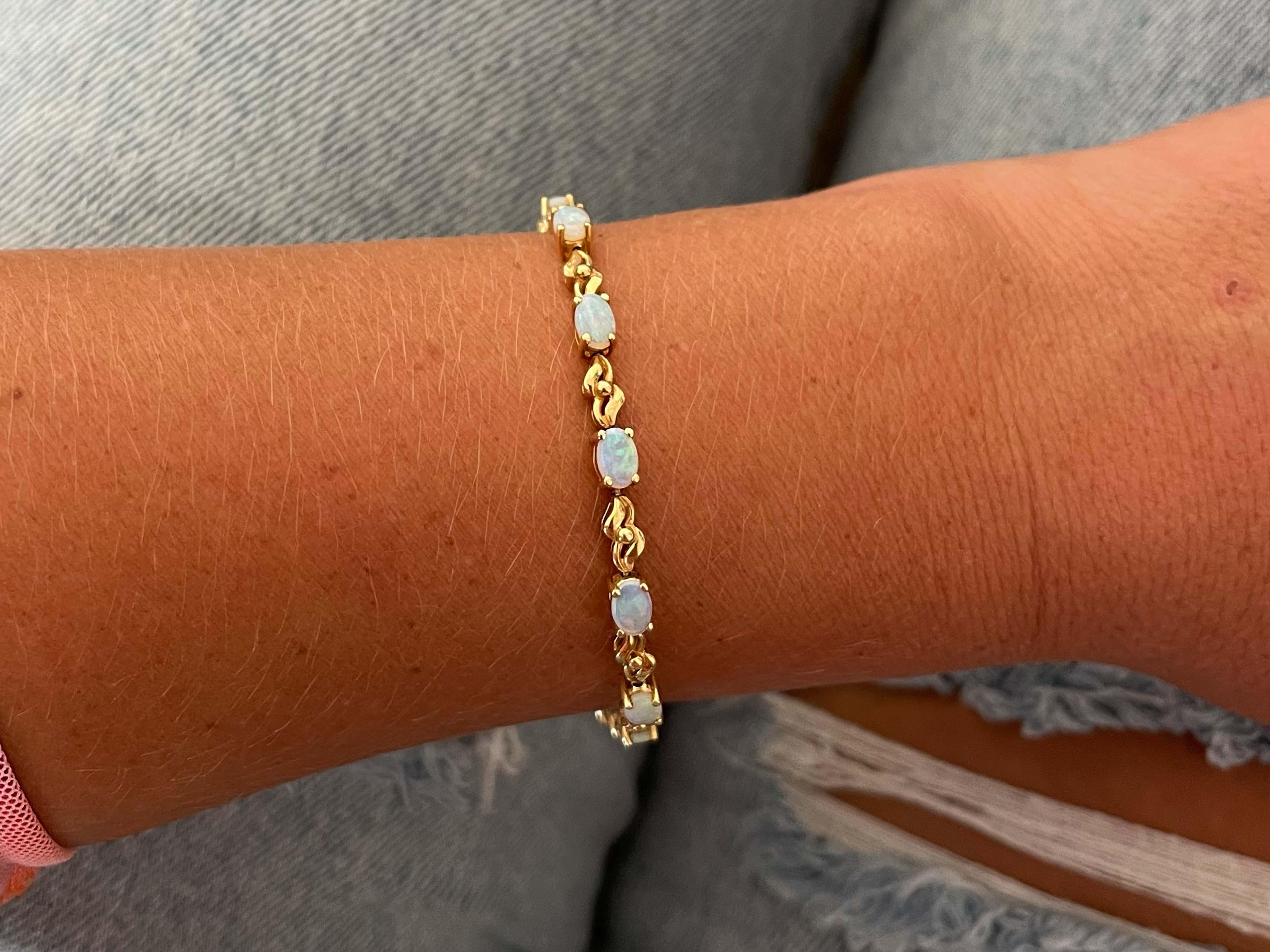 Bracelet Specifications:

Metal: 14k Yellow Gold

Opal Count: 13 Oval Opals

Opal Carat Weight: ~2.4 carats

Bracelet Length: ~7.25 inches

Bracelet Width: ~ 4 mm

Total Weight: 9.6 Grams

Condition: Vintage, Excellent

Stamped: 