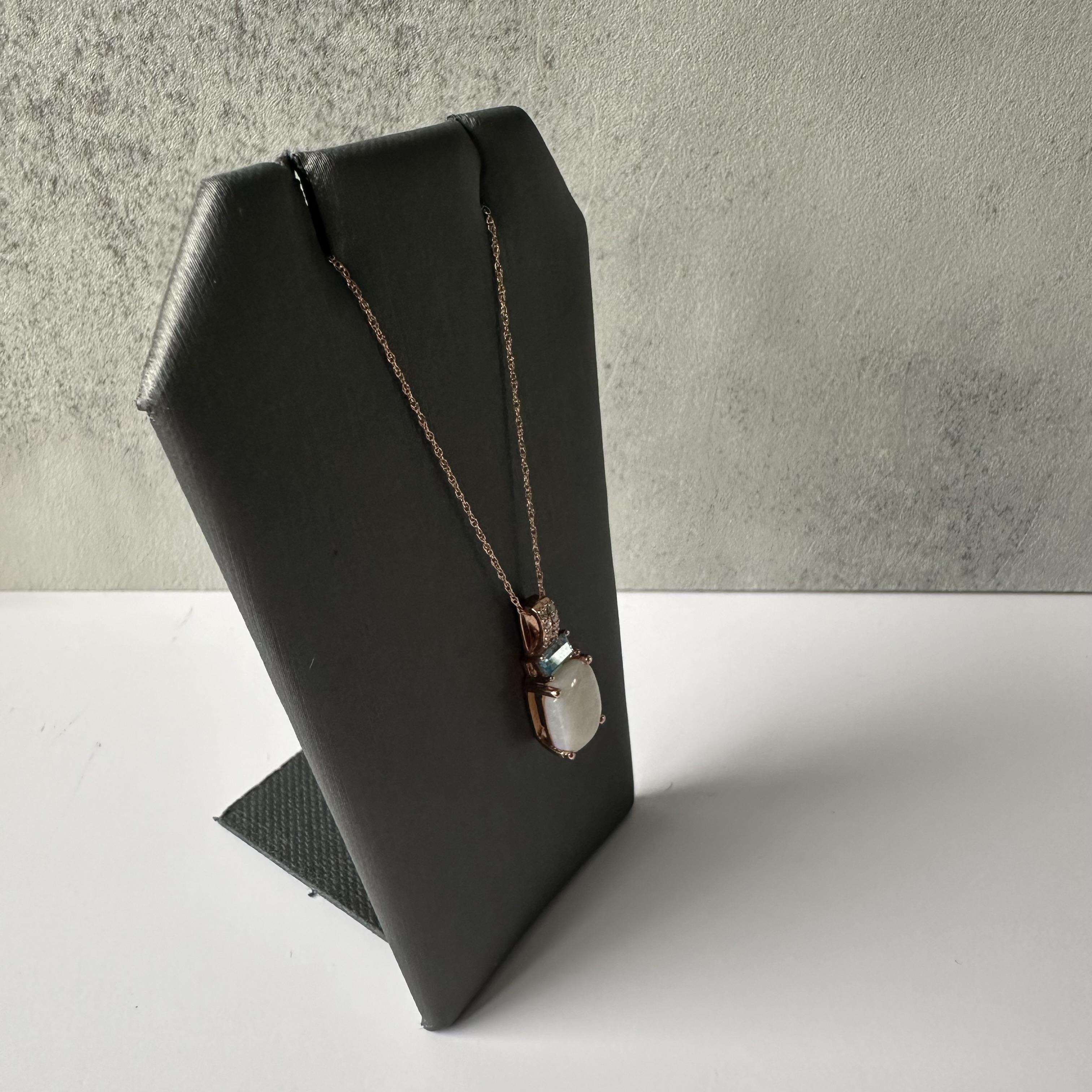 This stunning Opal, Topaz, and Diamond Necklace in 10kt Rose Gold is a beautiful combination of colors and sparkle. The fiery opal, striking blue topaz, and sparkling diamonds make this a perfect piece for adding elegance to your jewelry