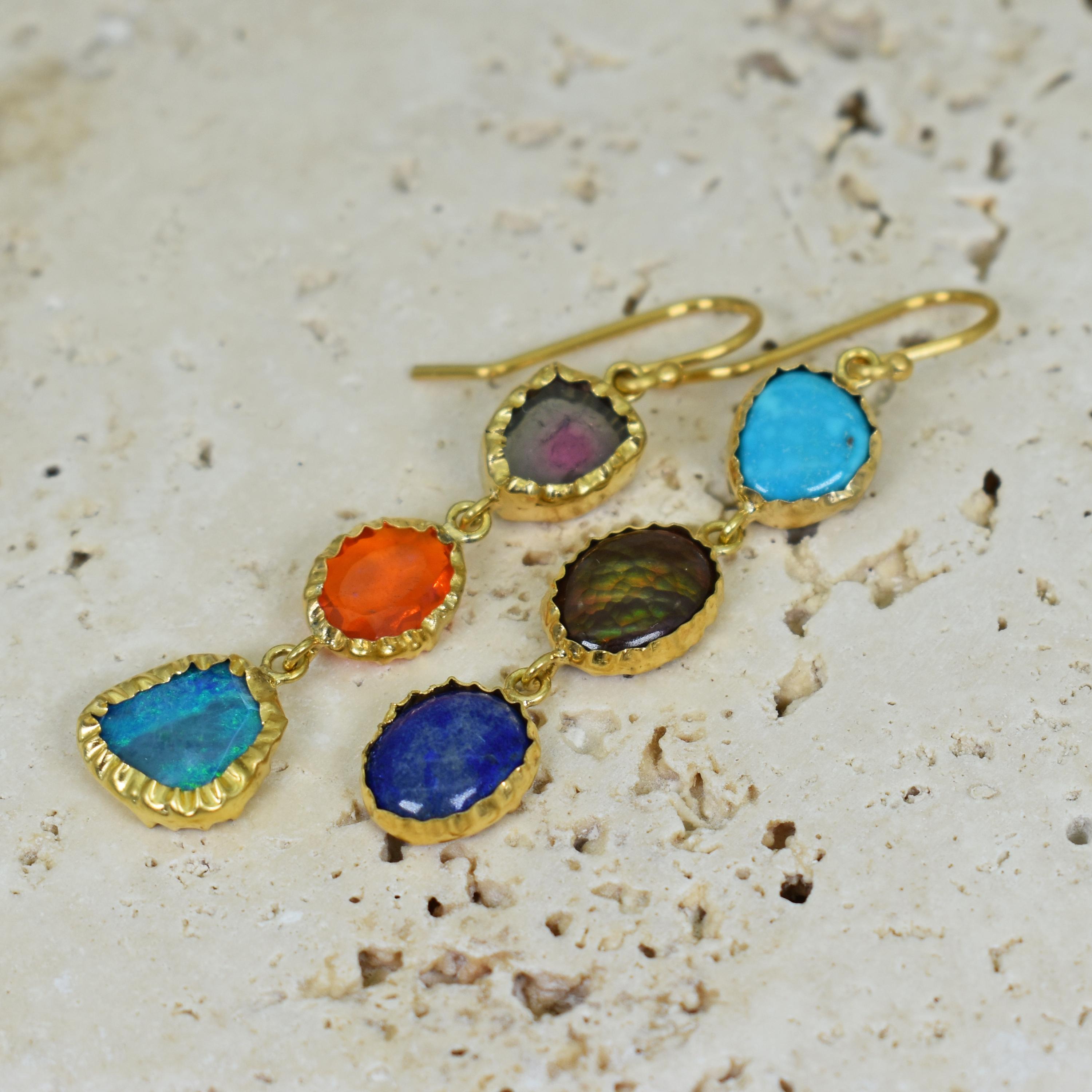 Multi-gemstone, 3-tier 22k yellow gold dangle earrings featuring a colorful variety of Watermelon Tourmaline, Fire Opal, Australian Opal, Turquoise, Fire Agate and Lapis Lazuli gemstones. Earrings, including ear wires, are 2.19 inches in length.