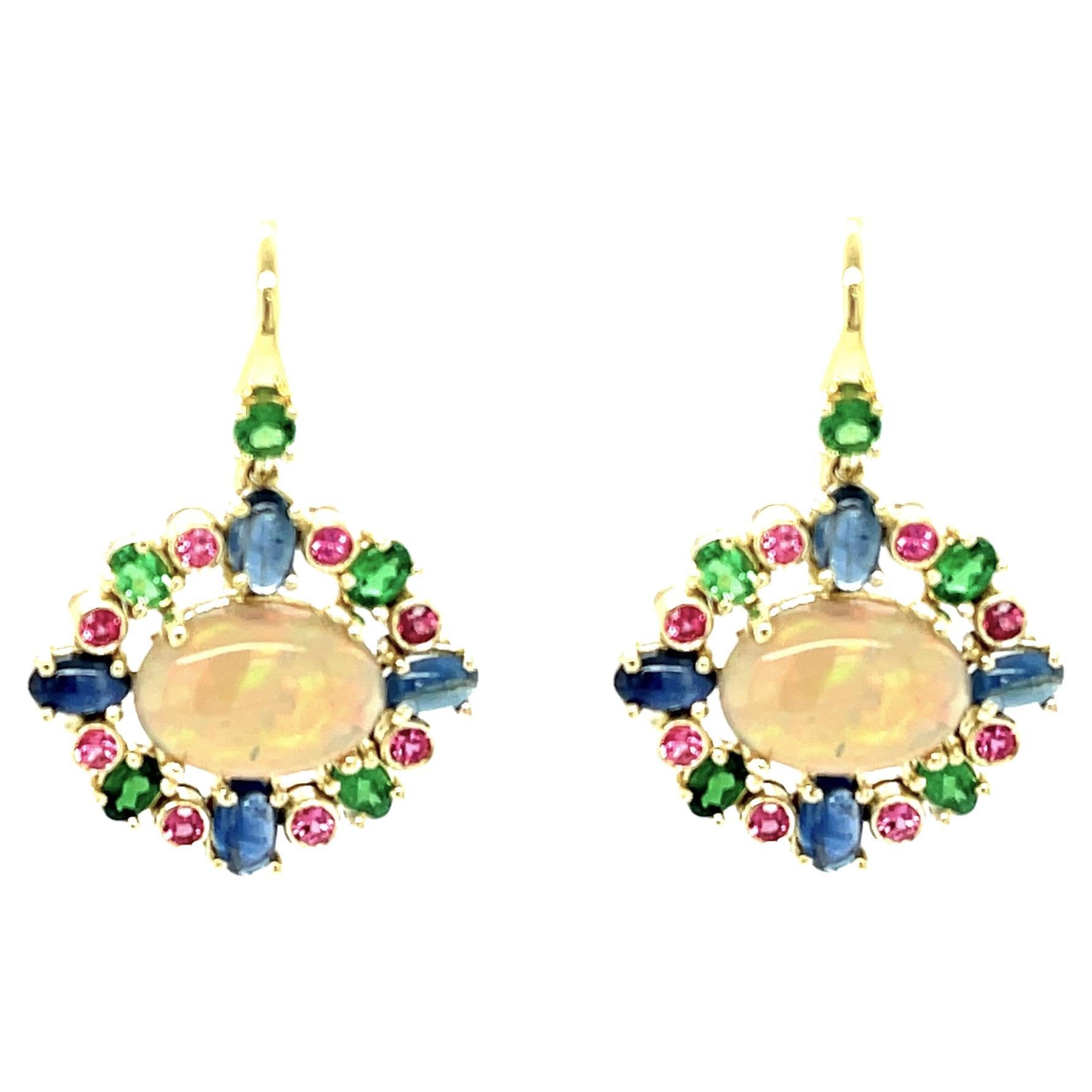18k yellow gold
These gorgeous dangle earrings feature a rainbow of colorful gemstones including Australian opals, African garnets, pink spinel and blue sapphires! The opals have beautiful play-of-color, exhibiting greens, lavenders, orange, yellow,