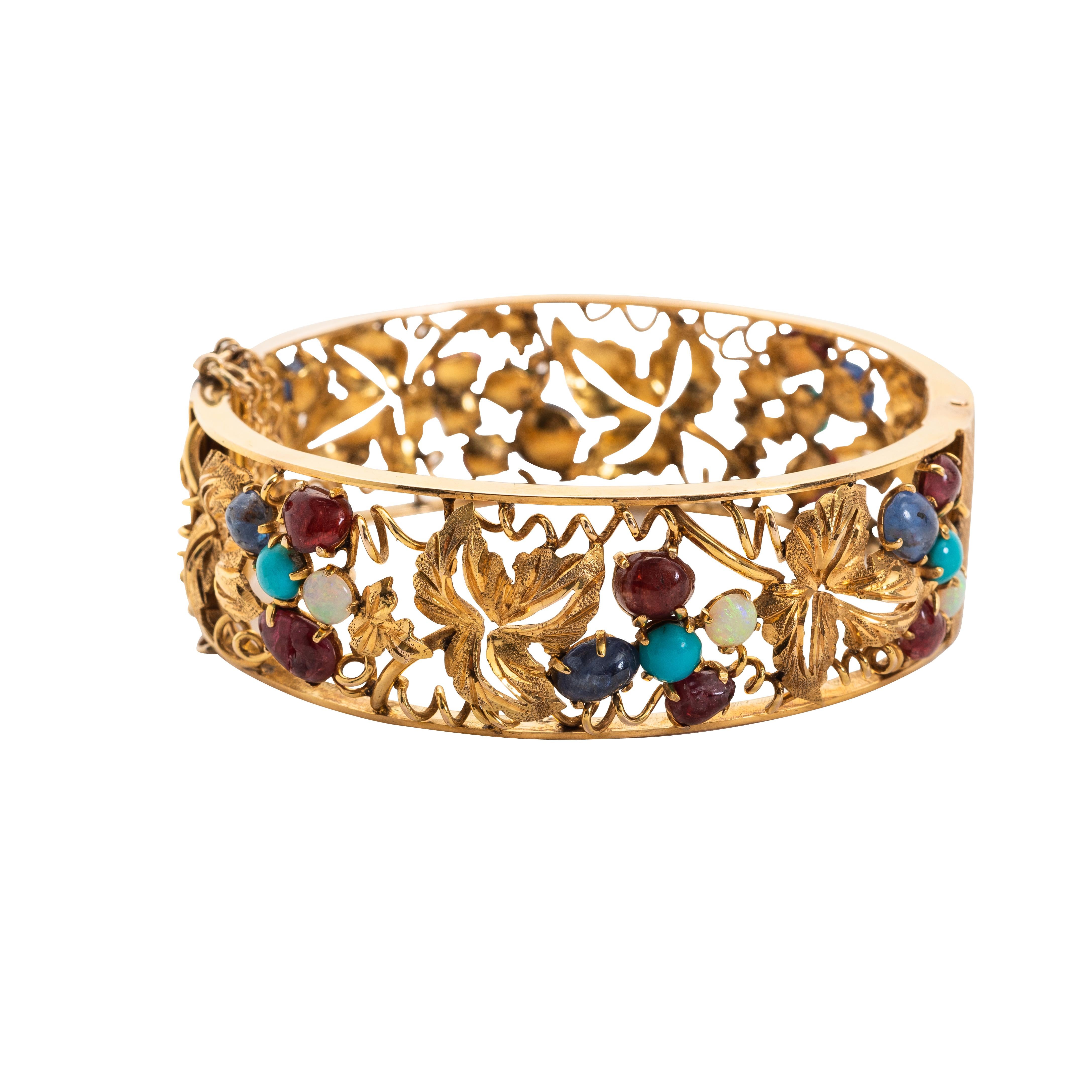 Opal, Turqoise and Gold Bangle-Bracelet
Of hinged design, set with Opals, Agate and Turquoise, gross weight approximately 23 dwts, internal circumference 2 1/4 in. (5.71 cm.)
mounted in 14kt yellow gold
