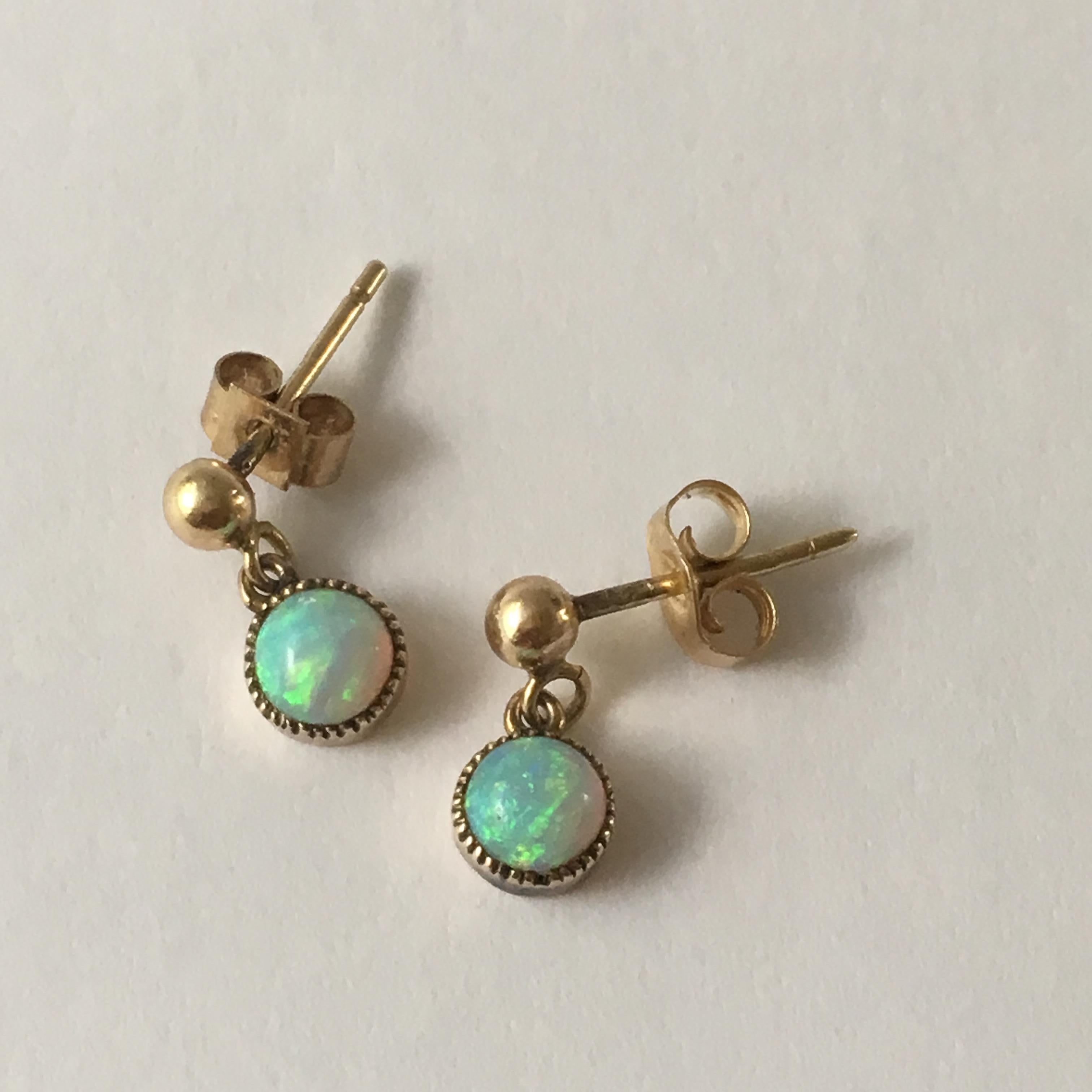 These beautiful, dainty opal drop earrings are extremely wearable and elegantly understated. They are stamped '9 375' for 9ct gold, so we can date them as pre-1978, but the exact letter date and assay office is no longer legible due to wear.  The
