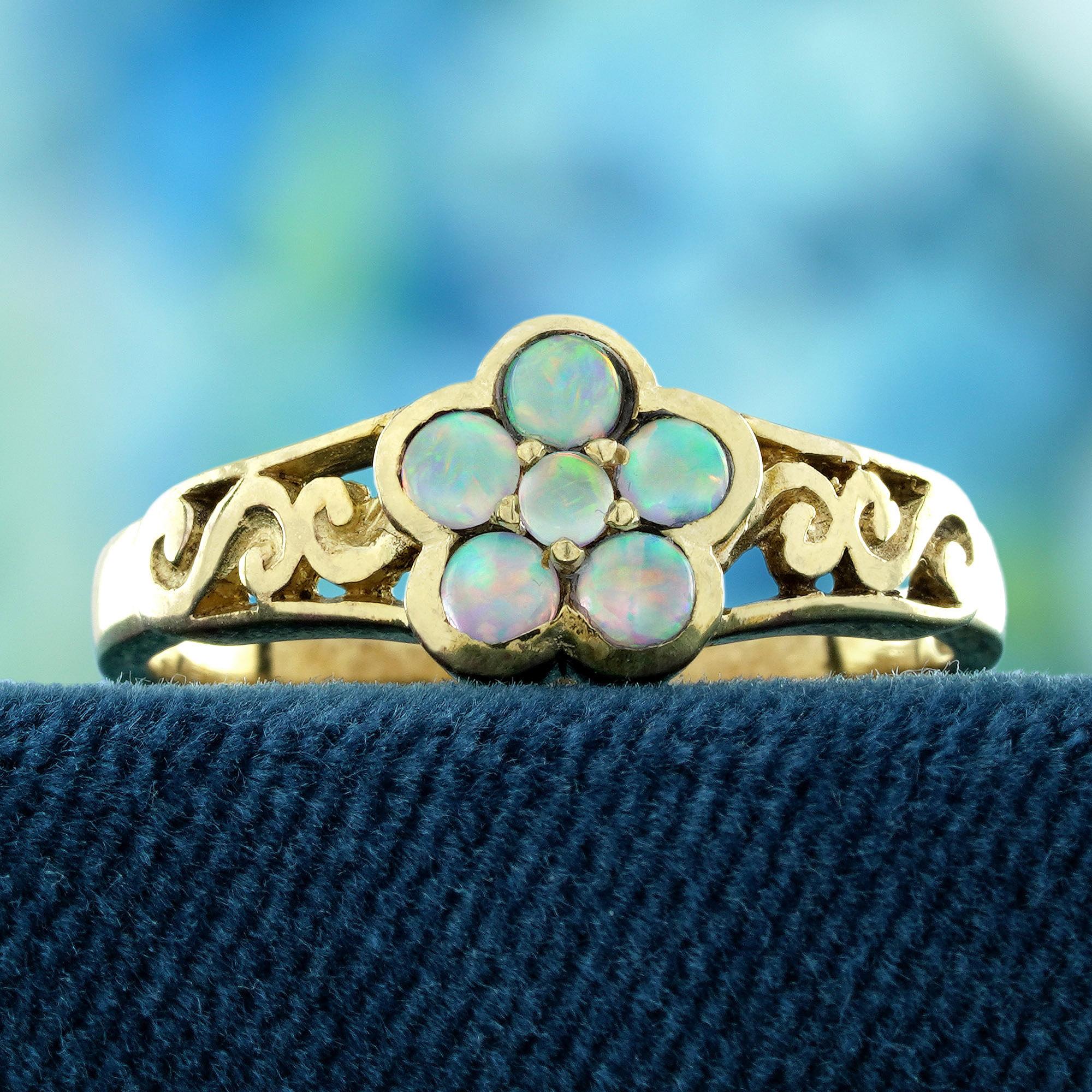 A true work of art, this vintage-style ring features a stunning natural opal, its radiant colors glowing like the petals of a rare flower in full bloom. Set in an exquisite filigree design, the delicate metalwork whispers of timeless elegance,