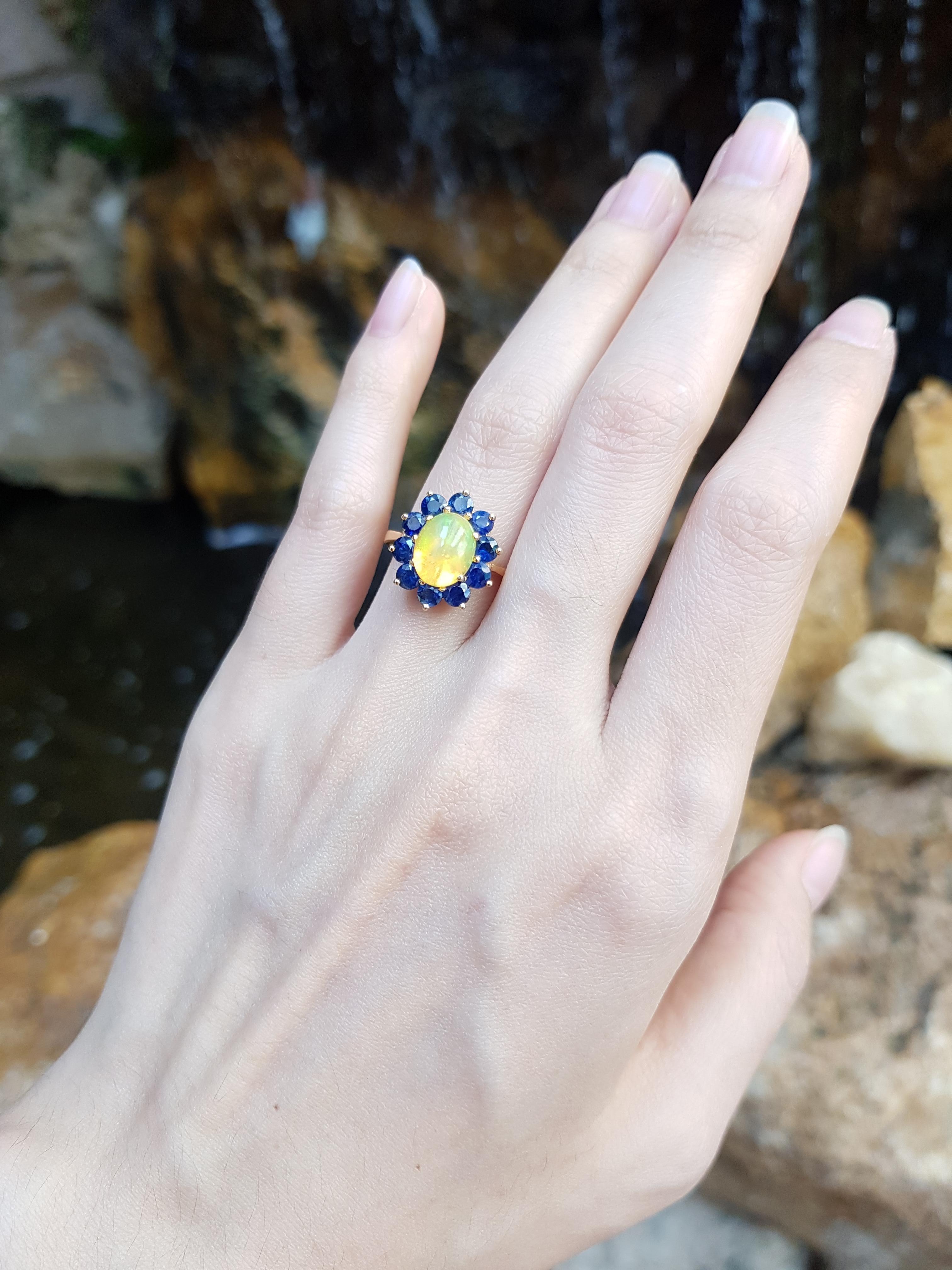Opal 1.72 carats with Blue Sapphire 1.41 Carats Ring set in 18 Karat Gold Settings 

Width: 1.1 cm
Length: 1.5 cm 
Ring Size: 55

