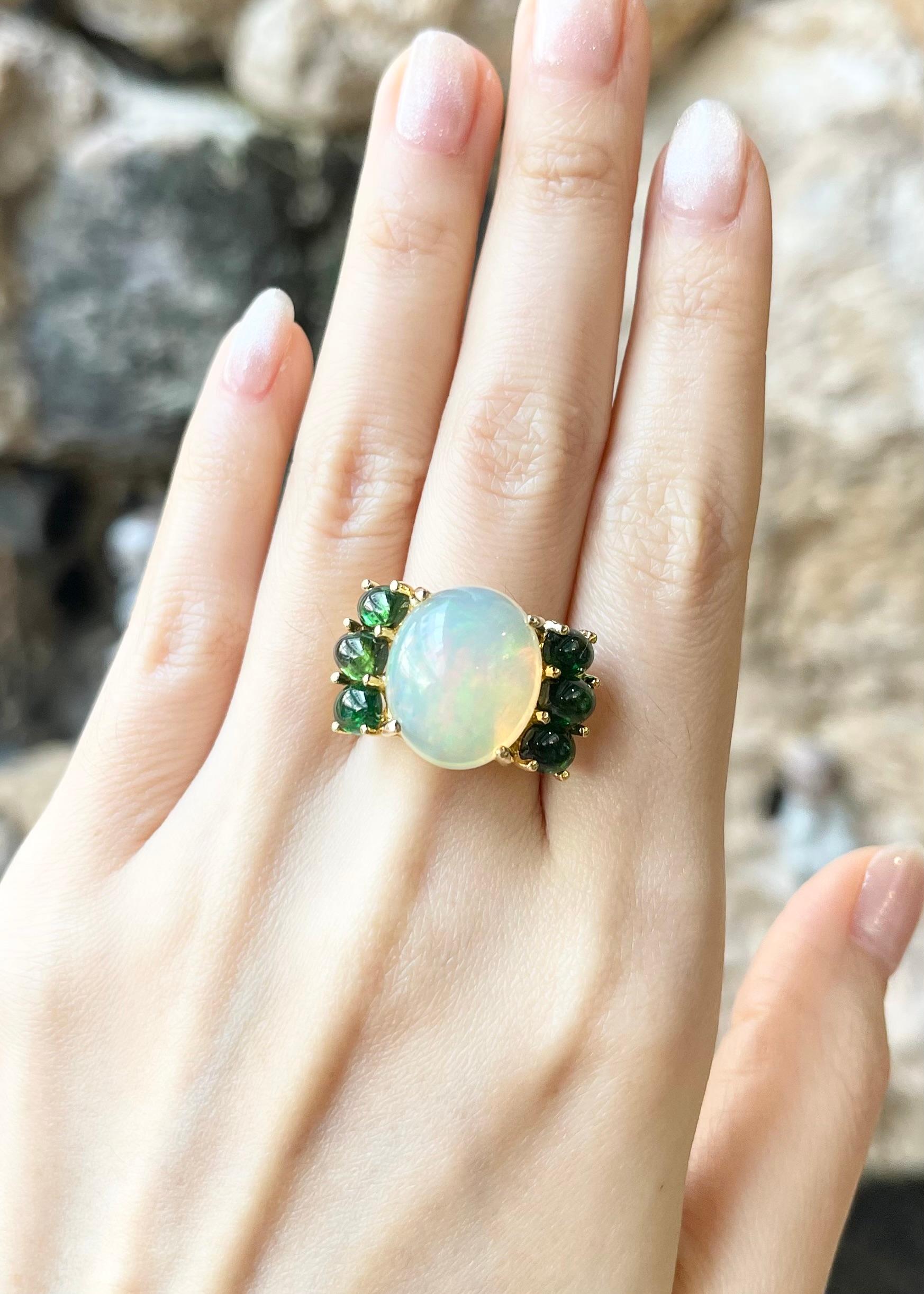 Opal 9.79 carats with Green Tourmaline 4.43 carat Ring set in 18K Gold Settings

Width:  2.5 cm 
Length: 1.5 cm
Ring Size: 53
Total Weight: 11.35 grams

