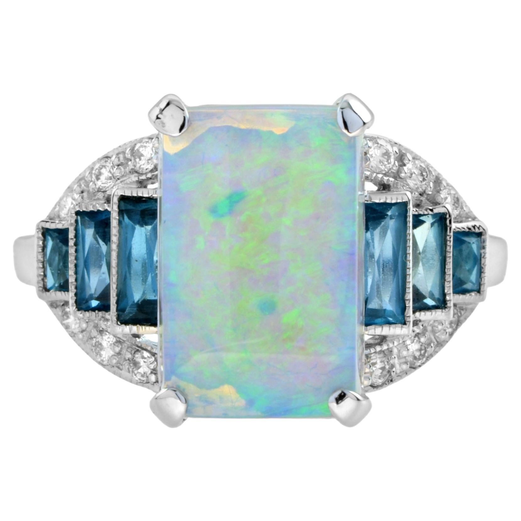 This Art Deco style opal ring features a 2.38 emerald cut authentic opal with baguette cut London blue topaz and diamond on either side. The lovely opal is set with four prongs. The French cut London blue topaz and diamonds are set on both side and