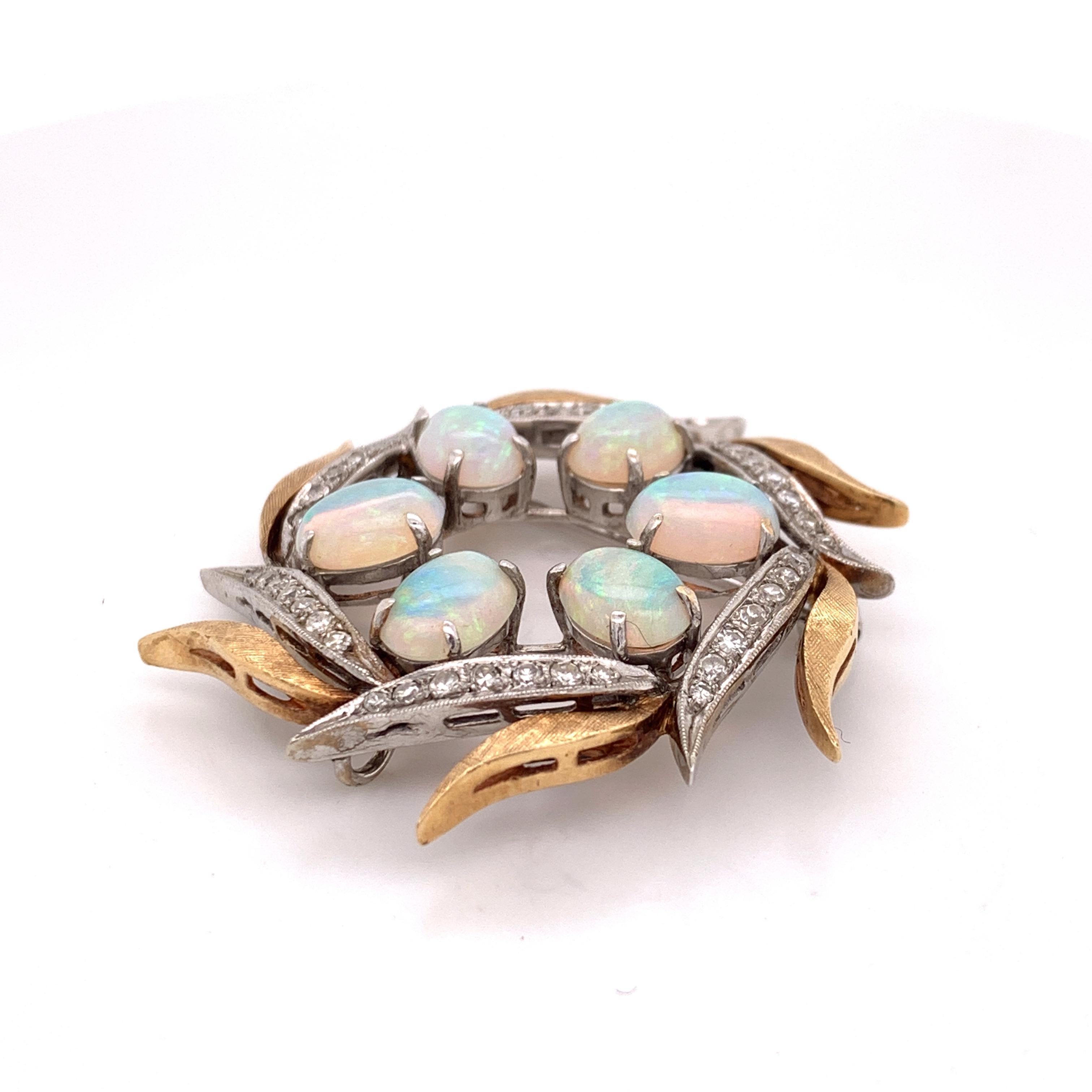 This gorgeous statement brooch can also be worn as a pendant. It features six beautiful opals surrounded by gilded leaves and adorned by 0.5cts of diamonds. The alternating 14K Yellow and White Gold leaves gives this piece a spectacular and unique