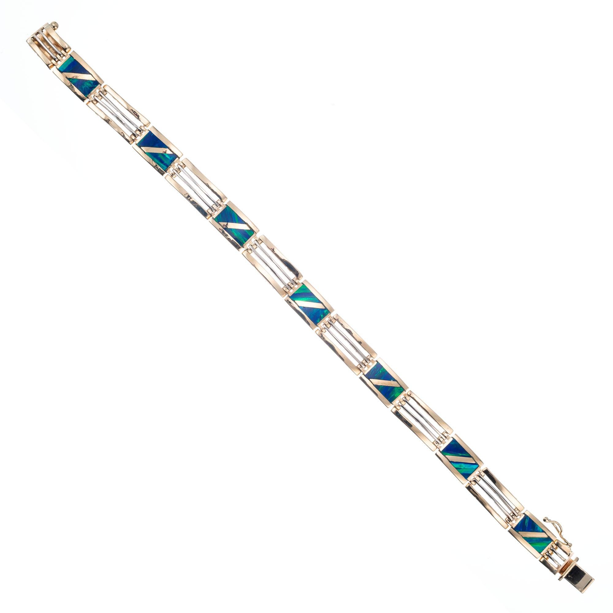 1970's Opal inlay square Link bracelet in 14k yellow and white gold. 8.25 length

14 triangular opal slices 
14k yellow gold 
14k white gold
Stamped: 14k
27.4 grams
Bracelet: 8.25 Inches
Width: 8.47mm
Depth: 3.36mm

