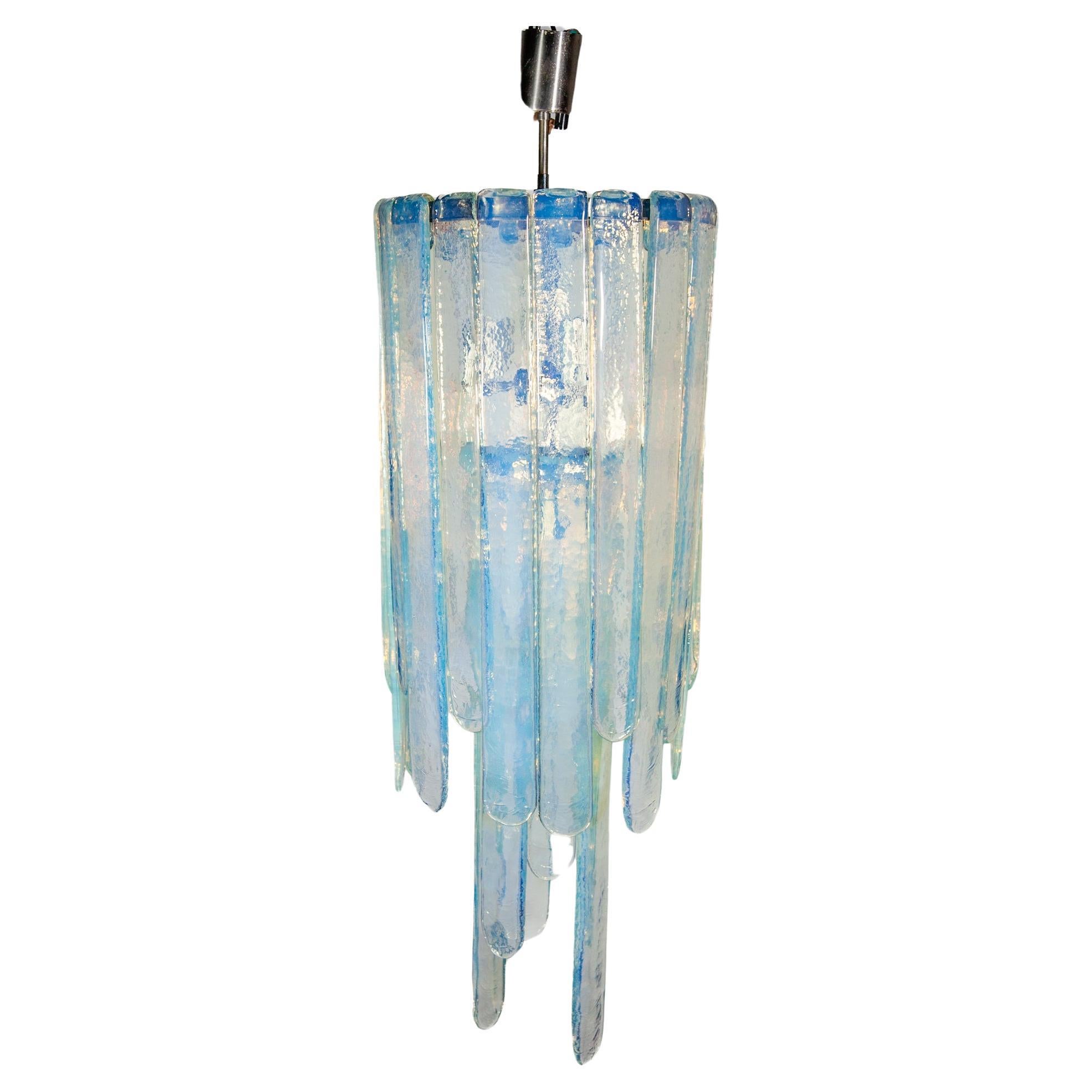 Vintage modern opalescent glass chandelier designed by Carlo Nason for Mazzega, Italy, 1960s in a blue opalescent art glass, consisting of three lengths of glass blades. It measures 98 cm tall in its current composition, but can be made longer or