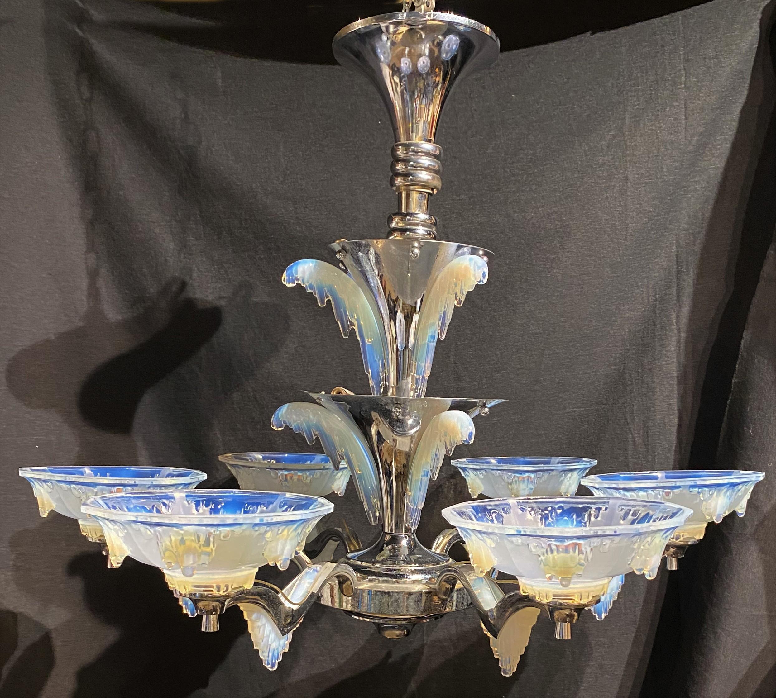 A stunning opalescent icicle glass Art Deco six light chandelier with nickel plated finish in the manner of Paris based designers Petitot & Ezan, circa 1930, for Atelier Petitot.  This three tier chandelier has two smaller upper tiers of icicles