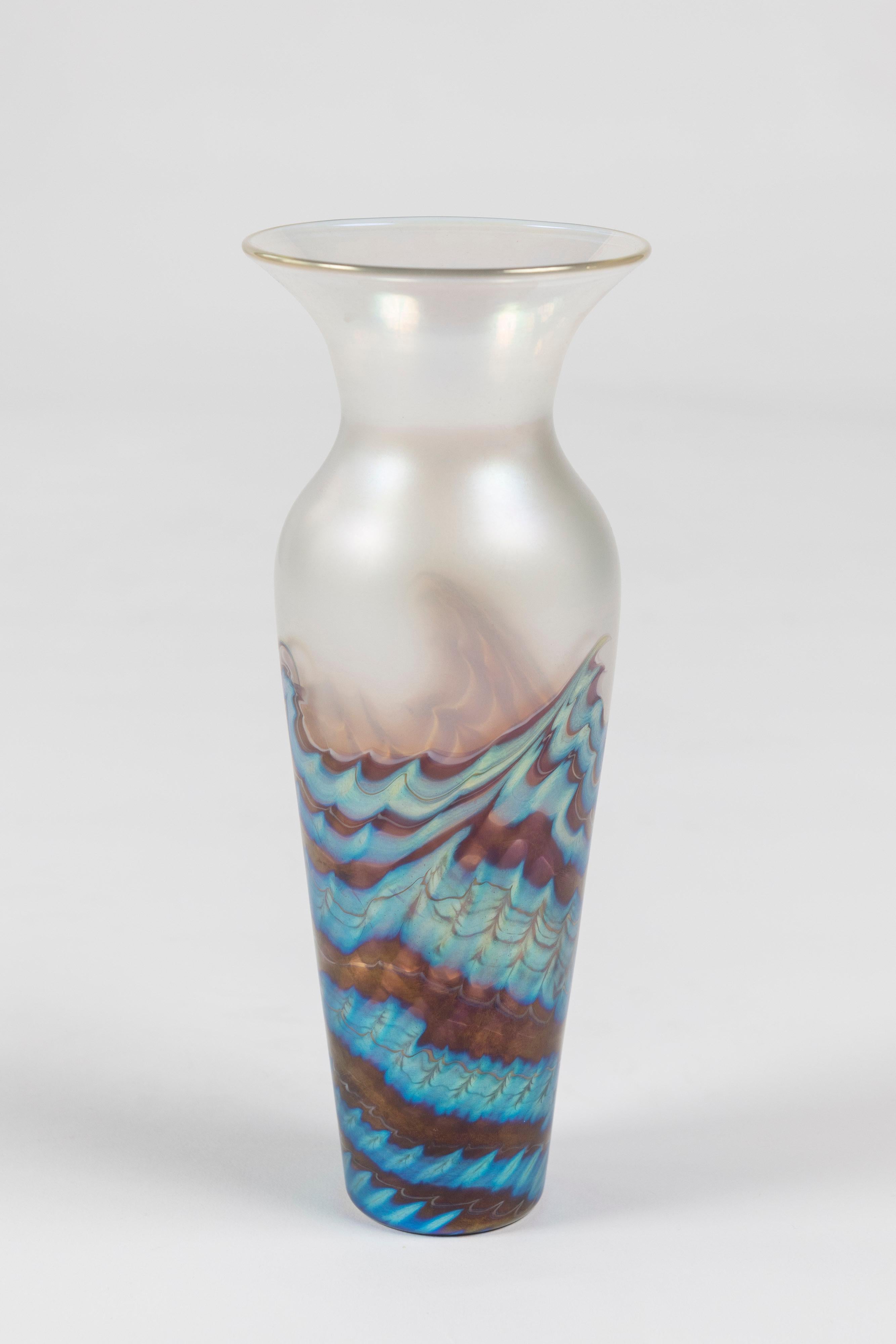 Lovely opalescent wave pattern tapered rim art glass vase by Lundberg Studios, is made in California and signed. Beautiful on its own or in a grouping.