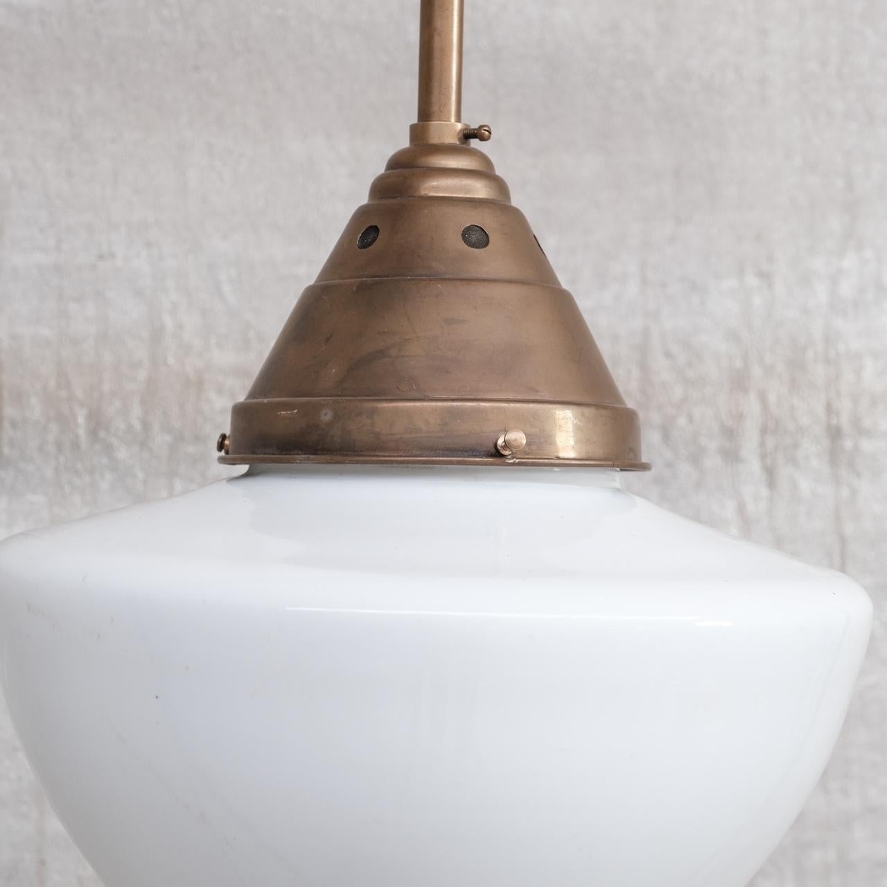 An opaline glass pendant light, with large original brass gallery. 

France, c1950s. 

Mid to larger sized drop shaped shade. 

No original chain or rose was retained, these are sourced easily online. 

Since re-wired and PAT Tested. 

Location: