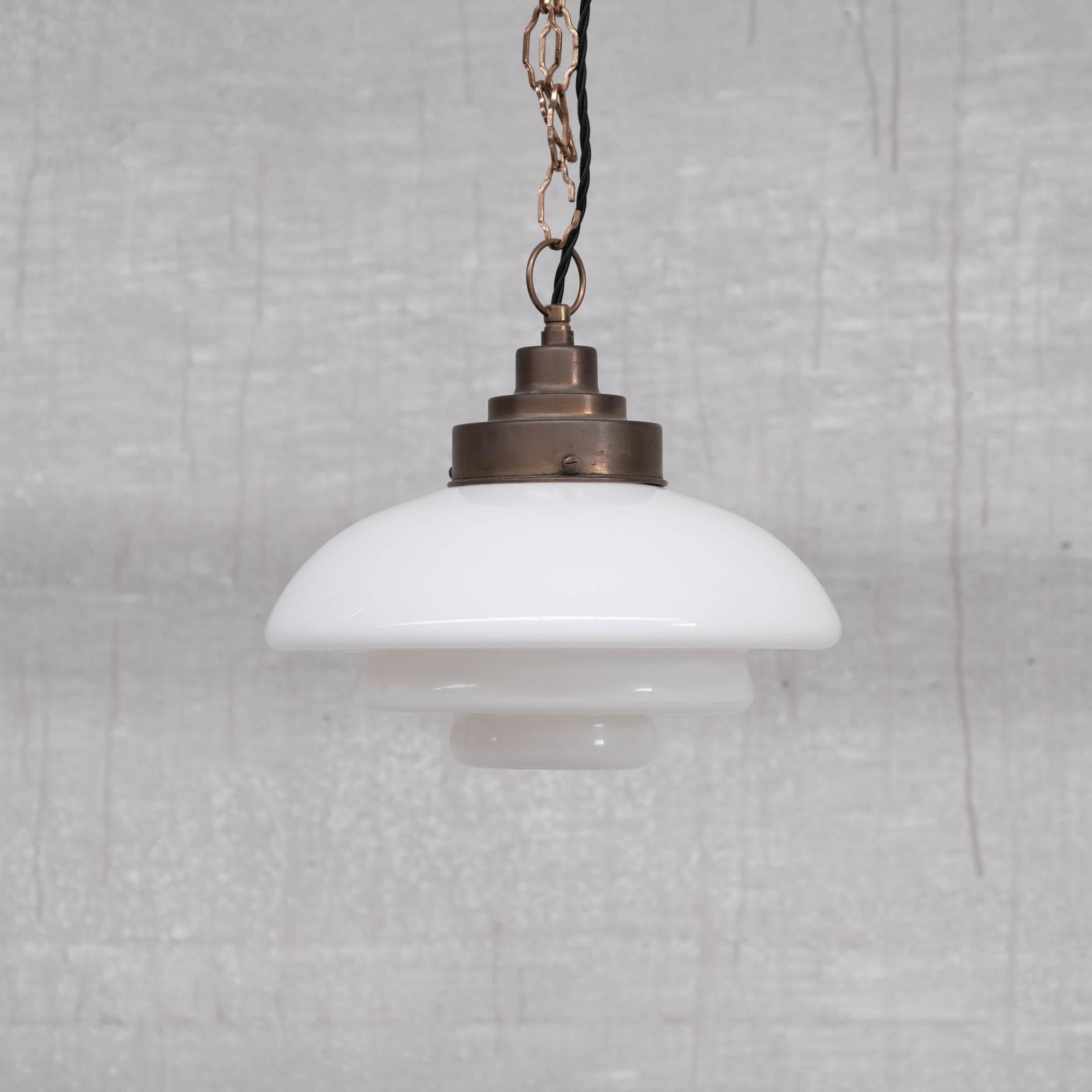 A single stepped opaline pendant. 

Naturally patinated brass gallery. 

France, circa 1950s.

Pleasantly stepped gallery which matches the glass. 

Re-wired and PAT tested. 

No original chain or ceiling rose was retained but these are