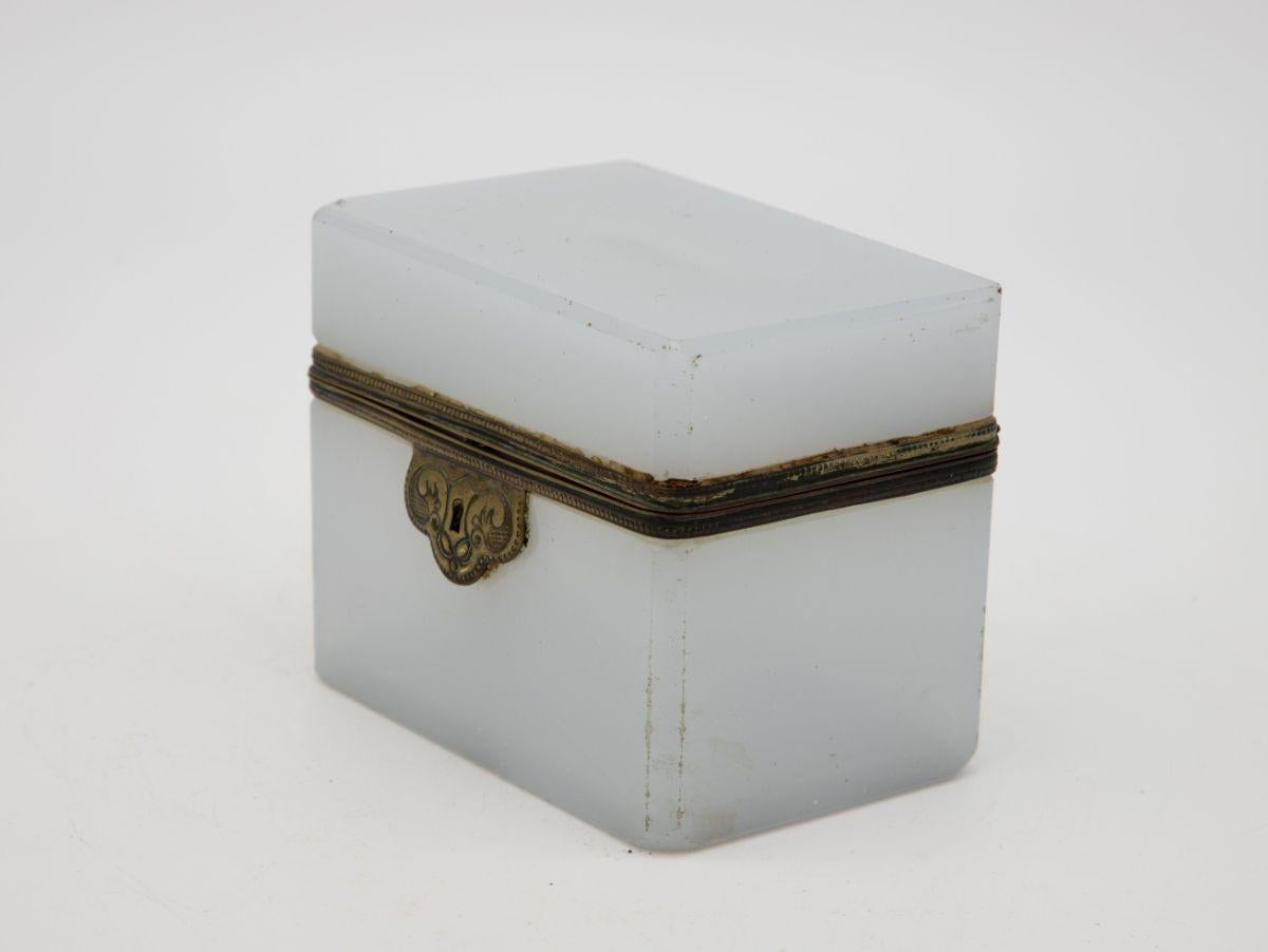 A small French 1860s white opaline glass box with bronze mounting. Wear consistent with age and use. Hairline crack on one side.