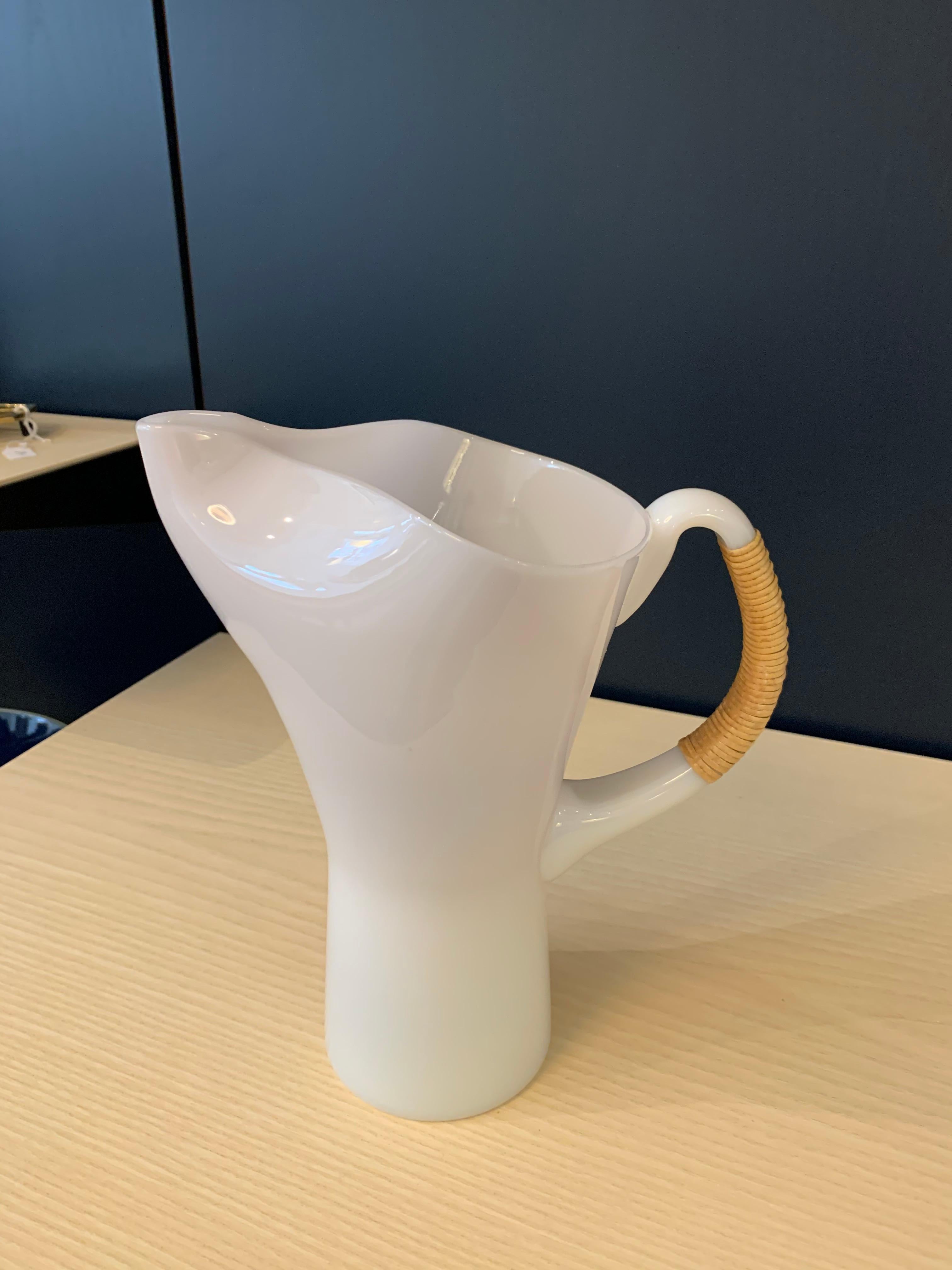 Opaline and cane Pitcher, designed in 1957 by Danish designer Jacob Eiler Bang for Kastrup Glasværk Denmark. The pitcher is part of a series of opaline glass utensils object series that was in production until 1965. 

Jacob E. Bang designed