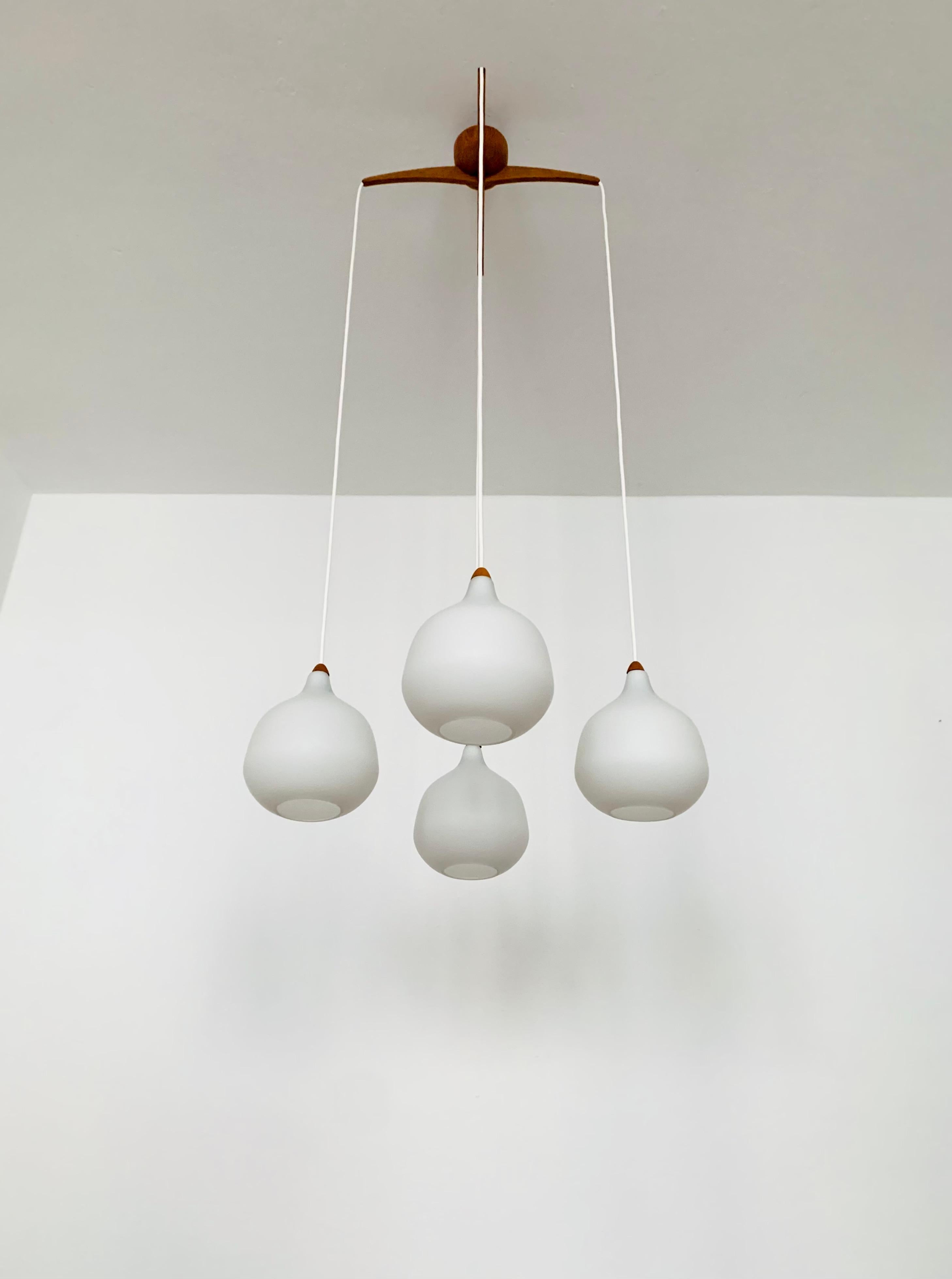 Wonderful Swedish opal glass pendant lamp from the 1960s.
Great and exceptionally minimalistic design with a fantastically elegant look.
Very nice oak wood details.

Manufacturer: Luxus
Design: Uno and Östen Kristiansson

Condition:

Very good