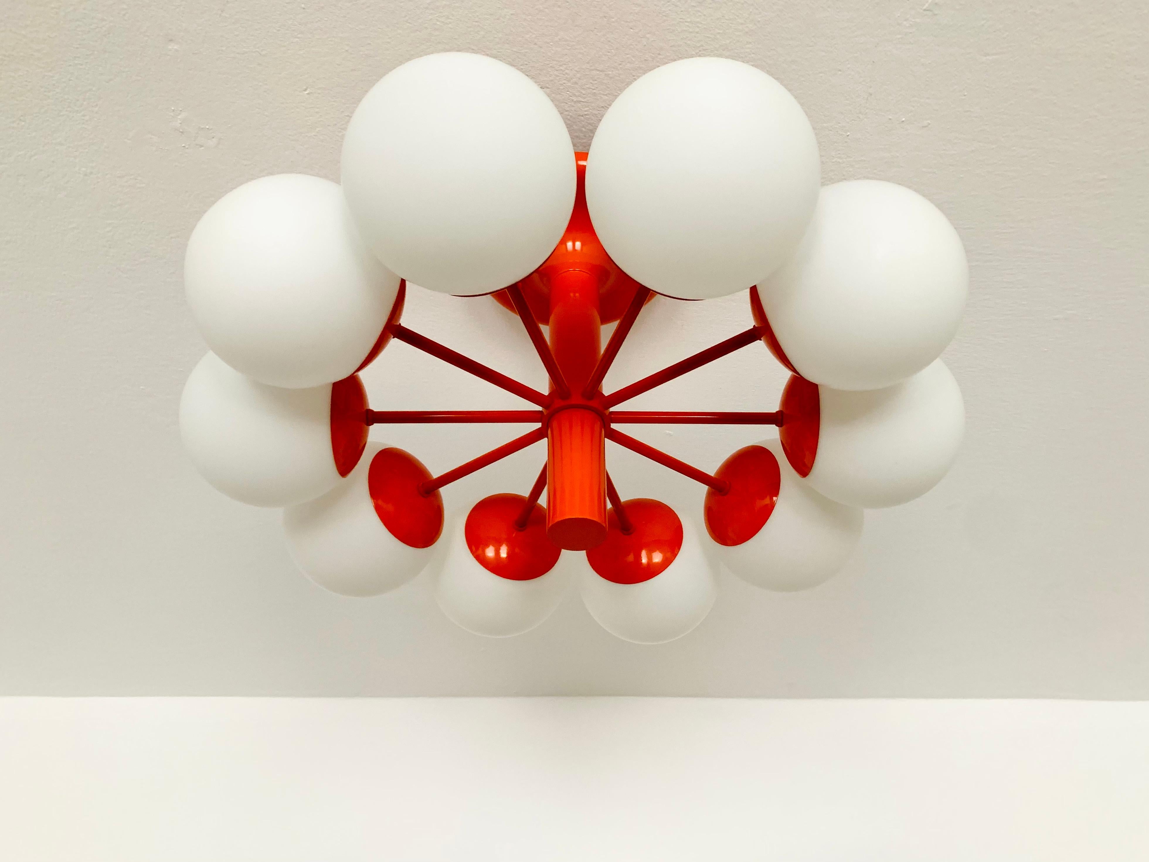 Extremely beautiful and large Sputnik flush lamp from the 1960s.
The 10 opaline lampshades spread a pleasant light.
The lamp has a very high quality finish.
Very contemporary and fantastic design.

Manufacturer: Kaiser