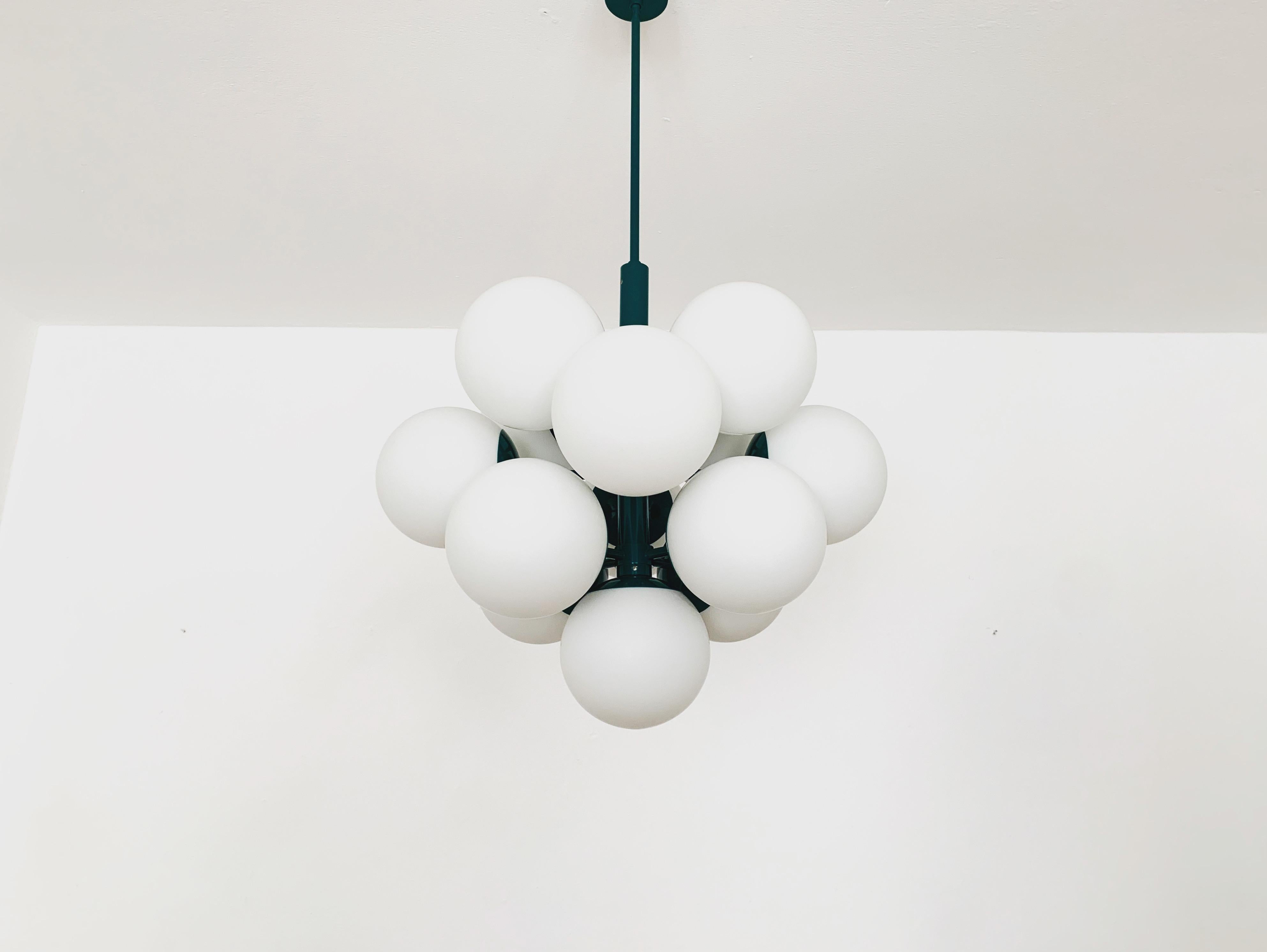 Extremely beautiful and large Sputnik chandelier from the 1960s.
The 13 opal glass lampshades spread a pleasant light.
The lamp has a very high quality finish.
Very contemporary design with a fantastic look.

Manufacturer: Kaiser