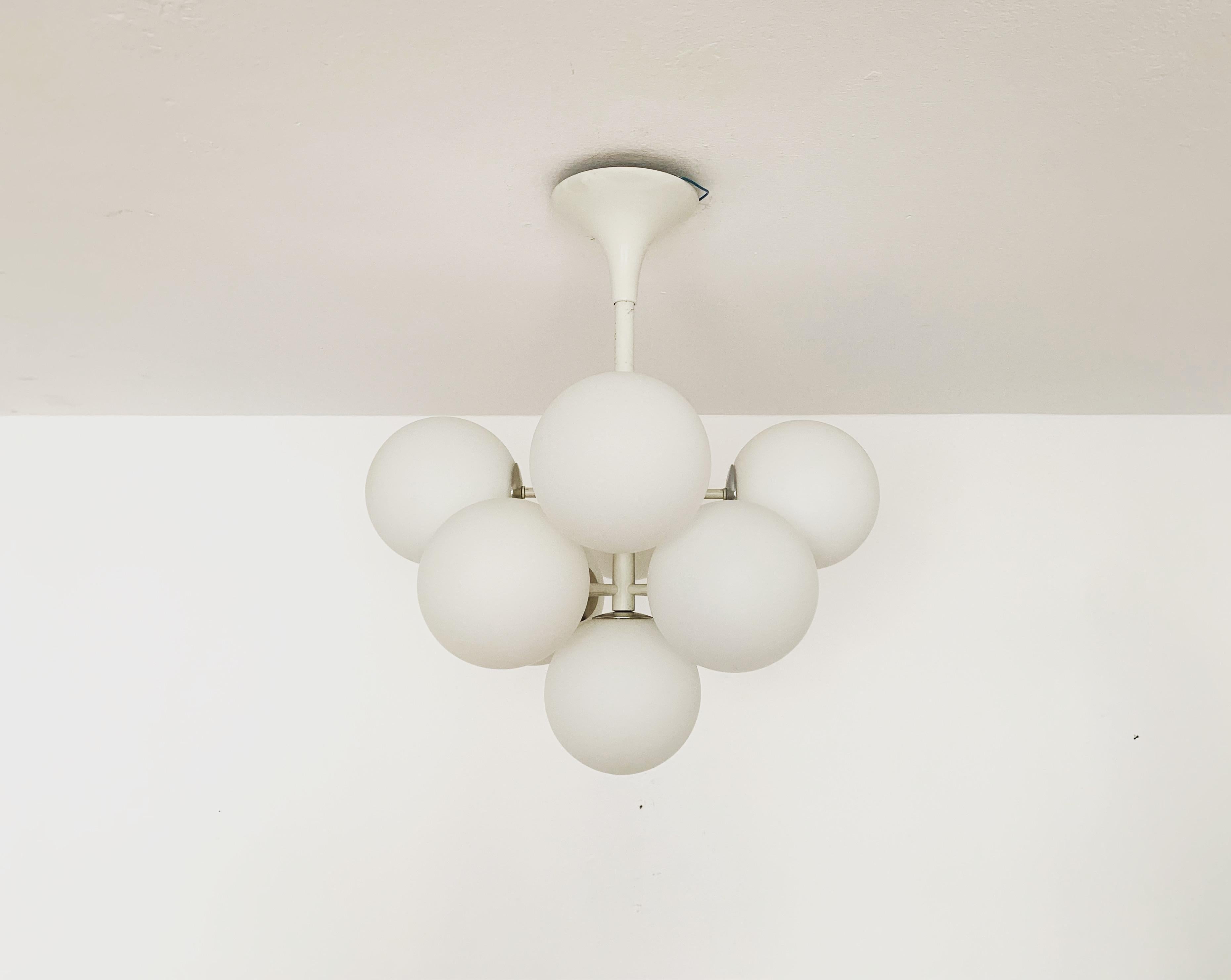 Extremely beautiful Sputnik chandelier from the 1960s.
The 9 opal glass lampshades spread a pleasant light.
The lamp has a very high quality finish.
Very contemporary design with a fantastic look.

Manufacturer: Temde.
Design: Max