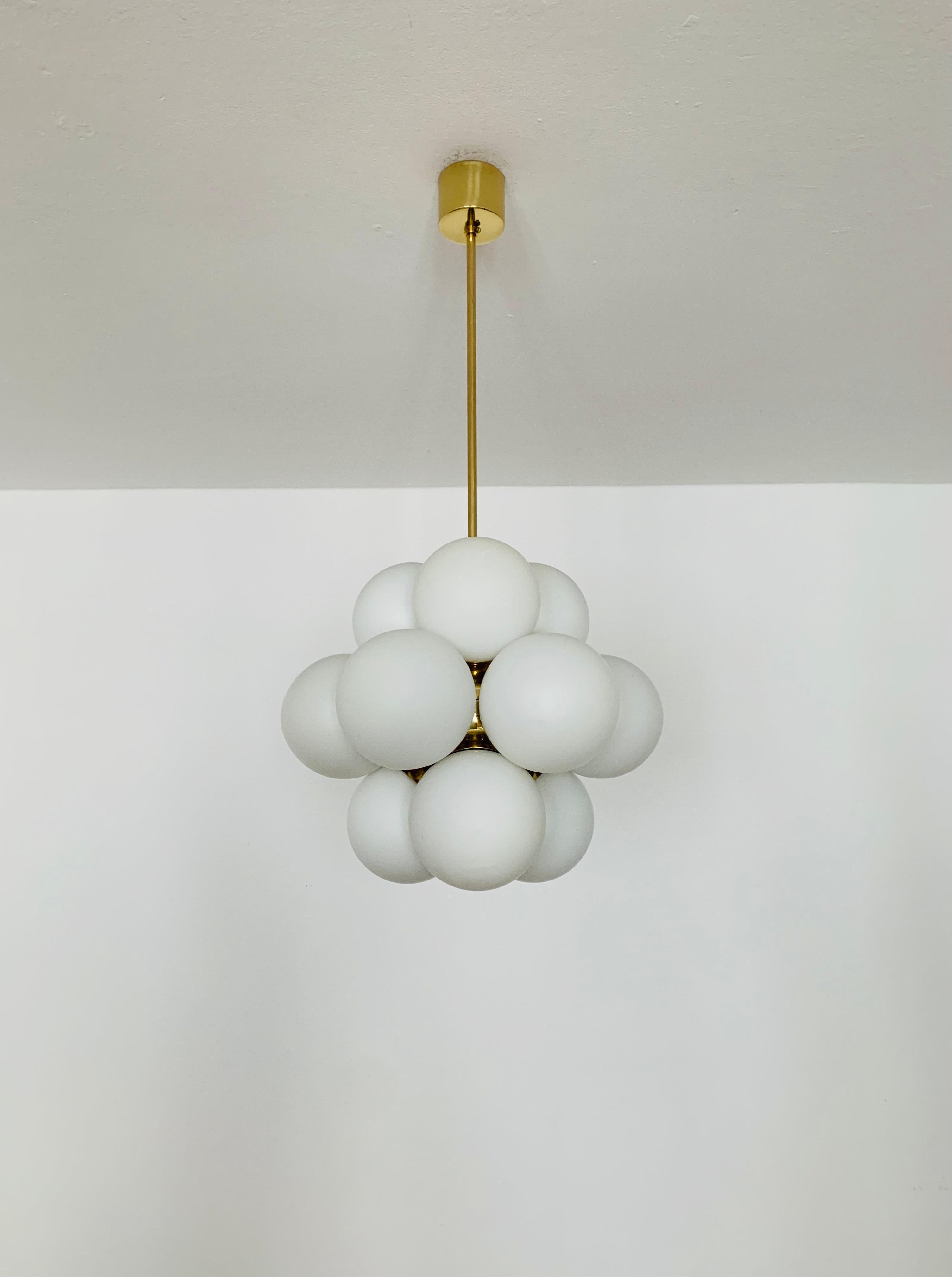 Extremely beautiful Sputnik chandelier from the 1960s.
The 12 opal glass lampshades spread a pleasant light.
The lamp has a very high quality finish.
Very contemporary design with a fantastic look.

Manufacturer: Kaiser Leuchten/ Kaiser