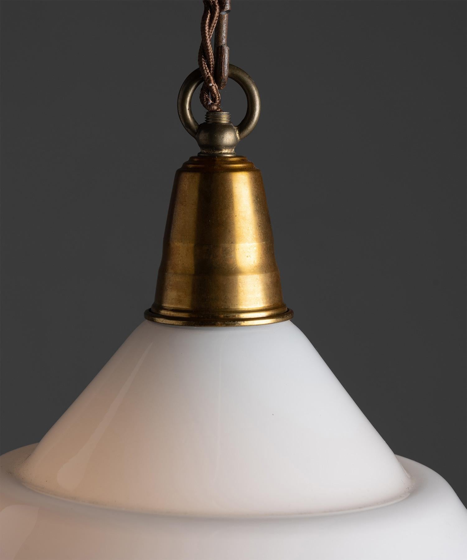 *Please note the price is per unit, and the lights are sold individually*

Opaline & clear conical pendant.

Europe Circa 1950

Opaline and clear glassed open bottom pendant with brass fitters.

Measures: 15.5