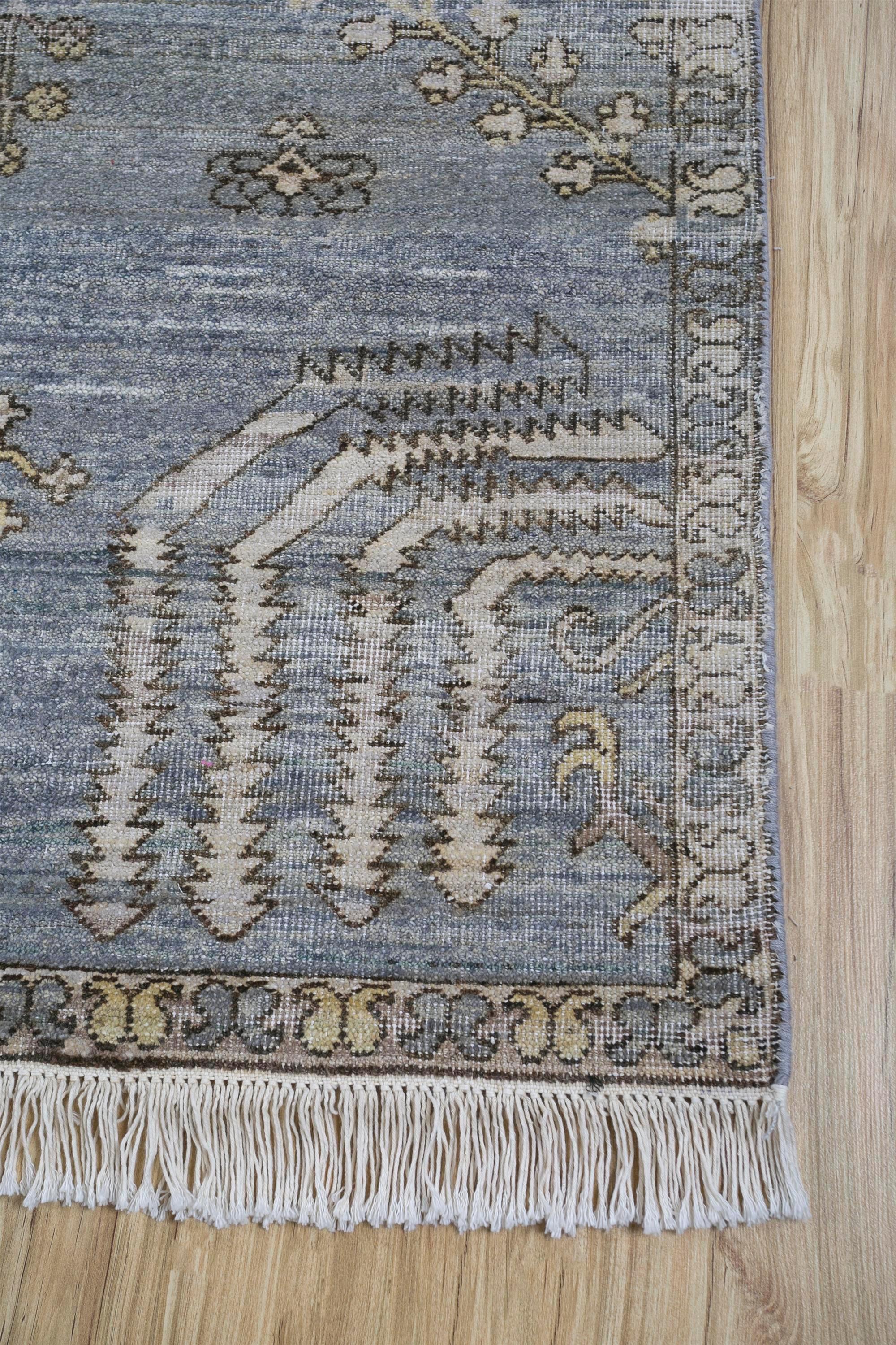 Are you looking for a rug that transcends the ordinary, a masterpiece that breathes life into your living space? Behold this Hand-Knotted Rug, a creation of exquisite artistry . Carved with intricate designs and patterns, it beckons you to a realm