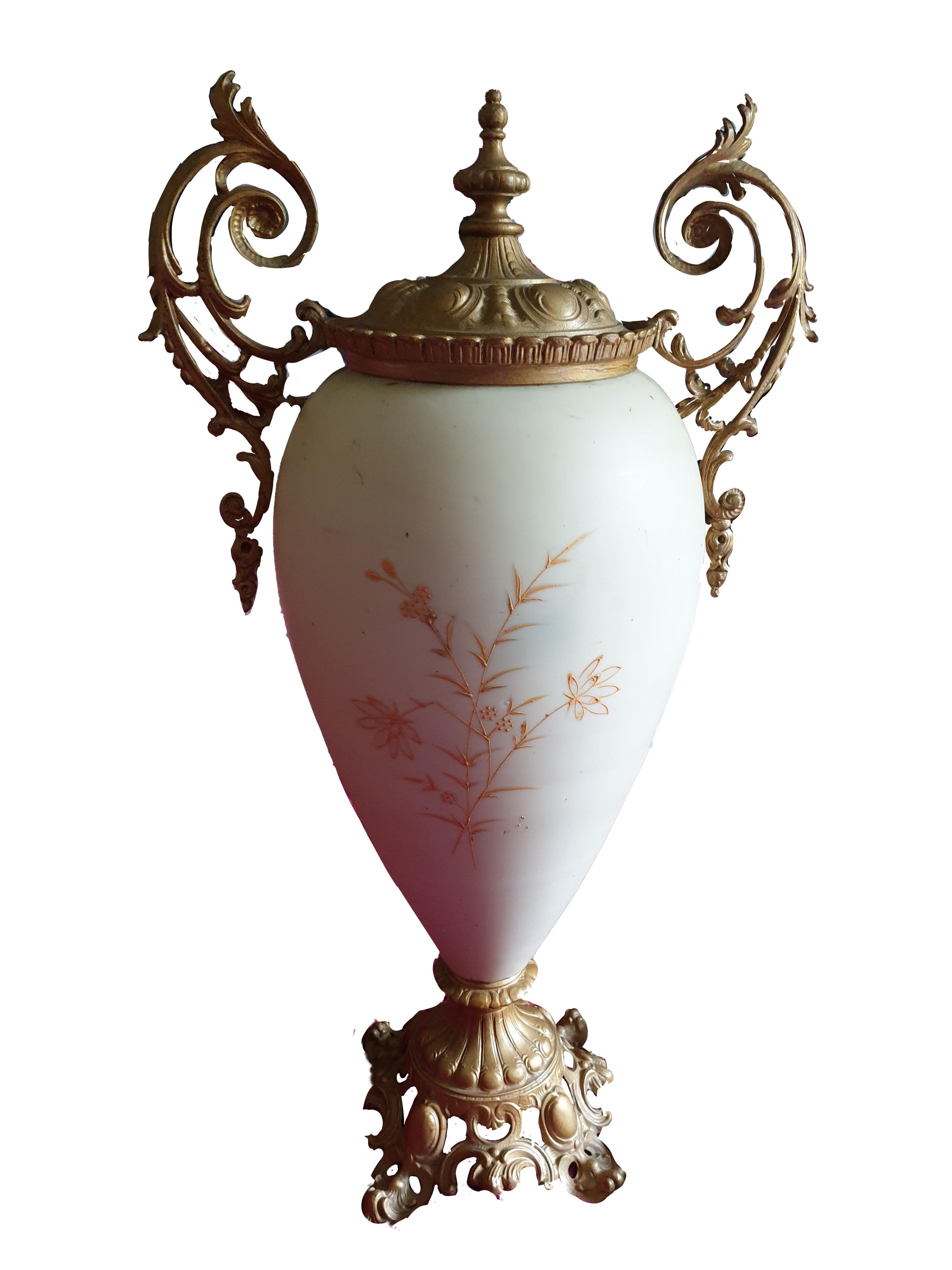 A large lidded Opaline decorative two handled vase in ovoid form with raised gilt floral paintings of pastel colour on both the front and back sides. Dating from mid 19th century and bulbous from the neck down it continuously tapers to the base. The