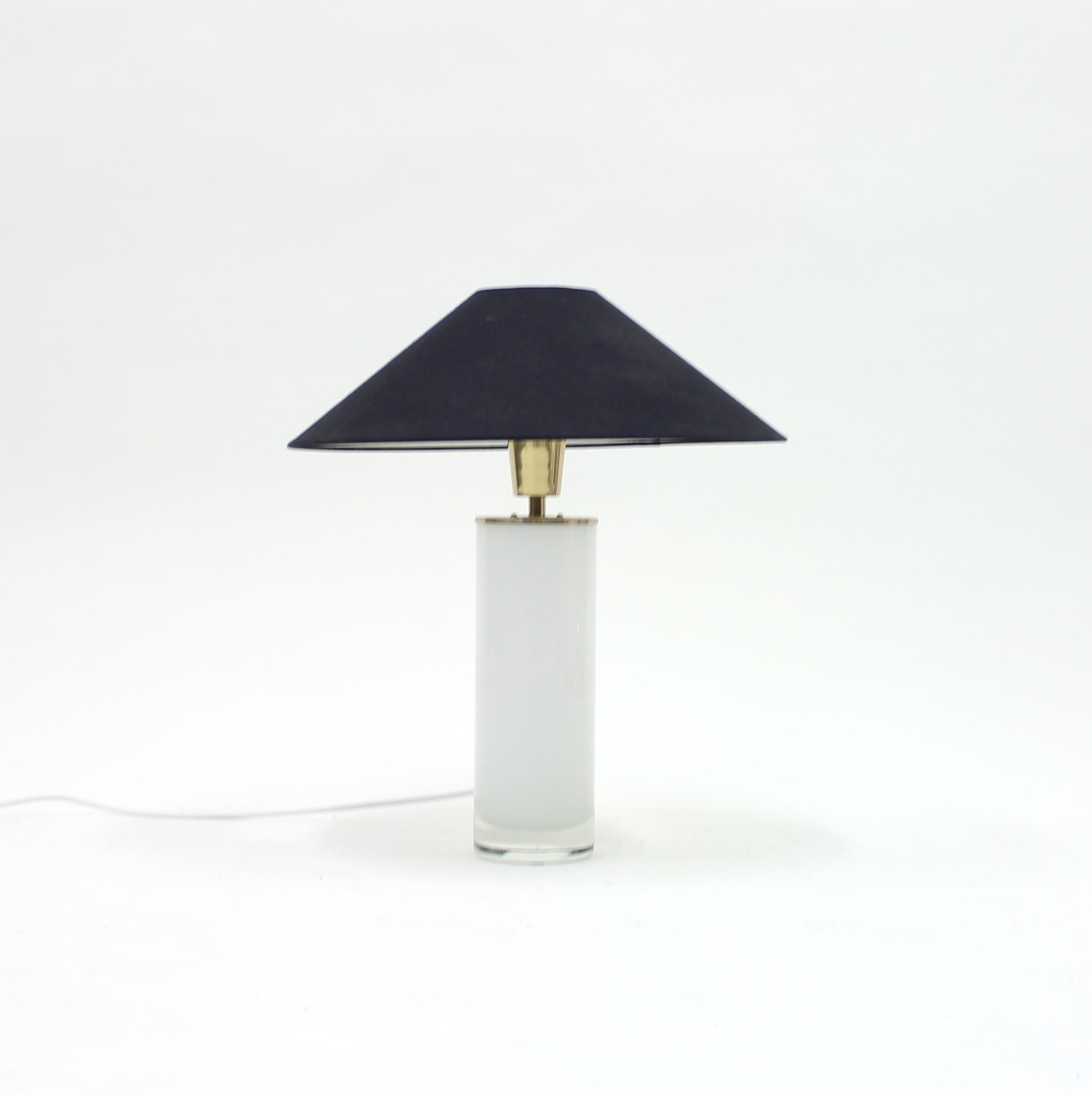 Table lamp with white opaline glass base and brass fittings, later black shade. Most likely Swedish but made by an unknown producer. Marked FAB 62 422. Newly rewired. Very good vintage condition with minor ware.