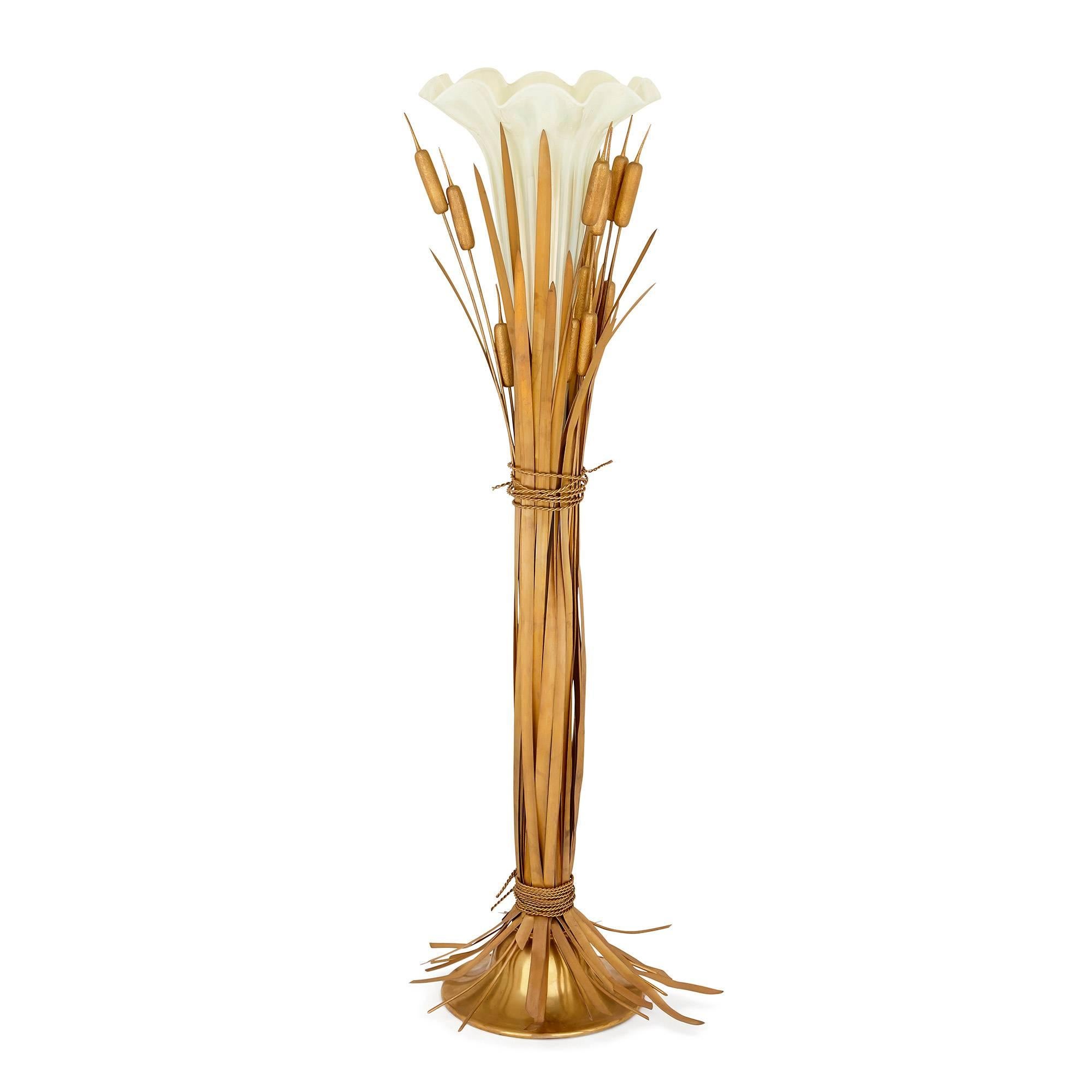 This stunning and large centrepiece is a beautiful piece with exquisite sculptural qualities. It is modelled as a central pale green opaline glass vase, delicately shaped as a long, slender flower head with a petal rim, with gilt brass reeds and