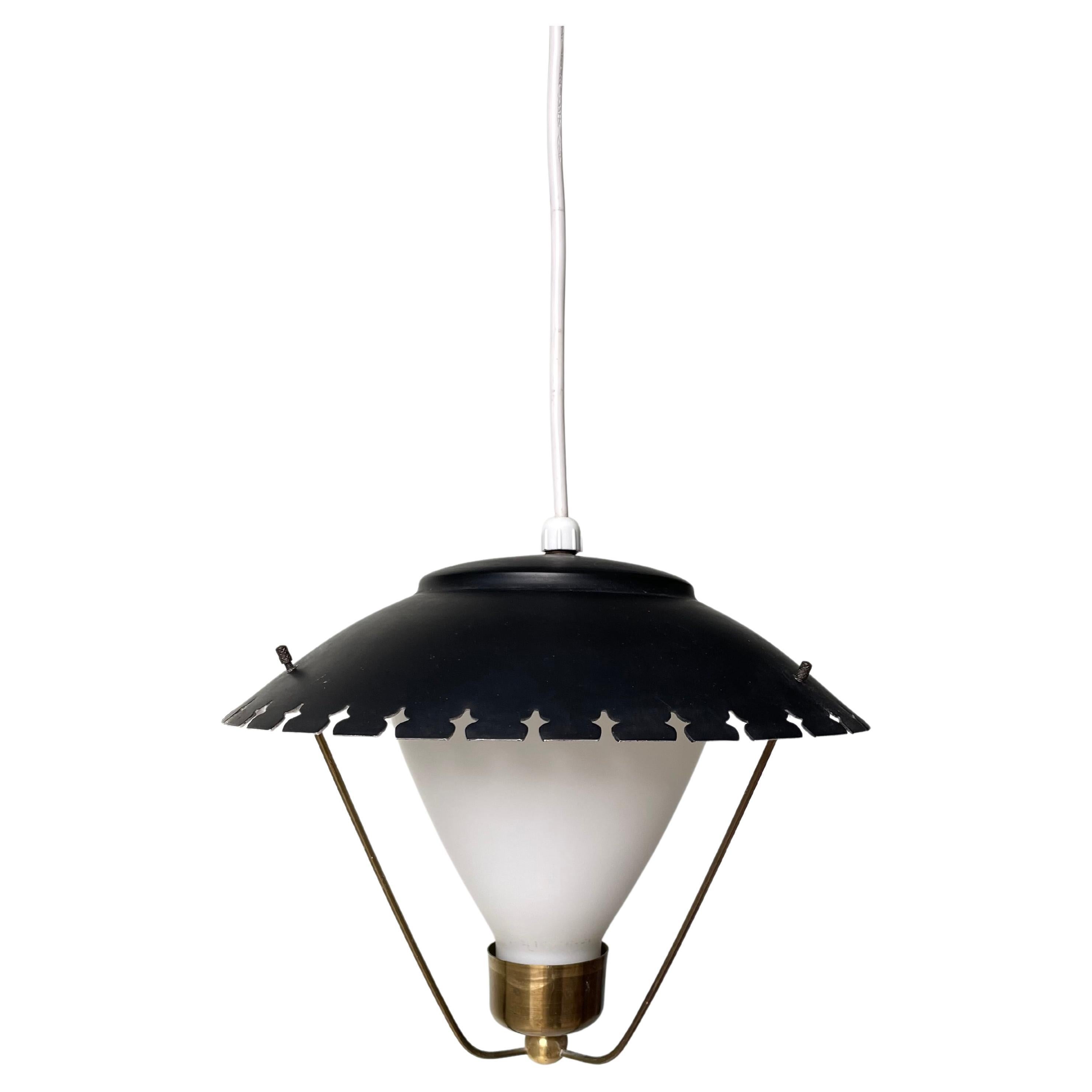 Classic Danish midcentury modern lighting design. Soft opaline glass on delicate brass mount with three thin arms on which the black roof with cross shaped edge rests. Attributed to Danish architect and designer Bent Karlby. Beautiful vintage